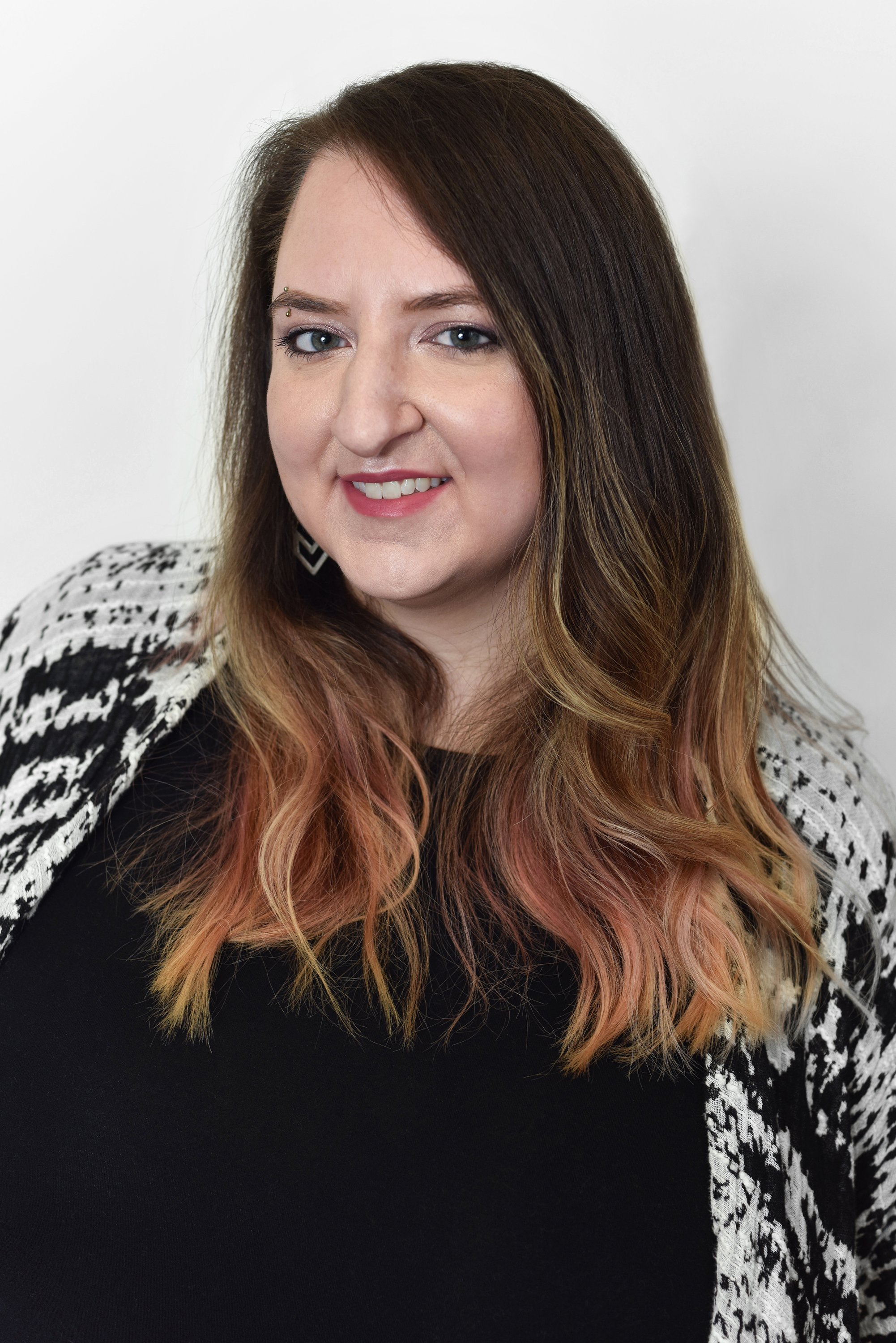  Corporate headshot of woman in a black top and black and white cardigan by Ari Scott, NYC headshot photographer. 