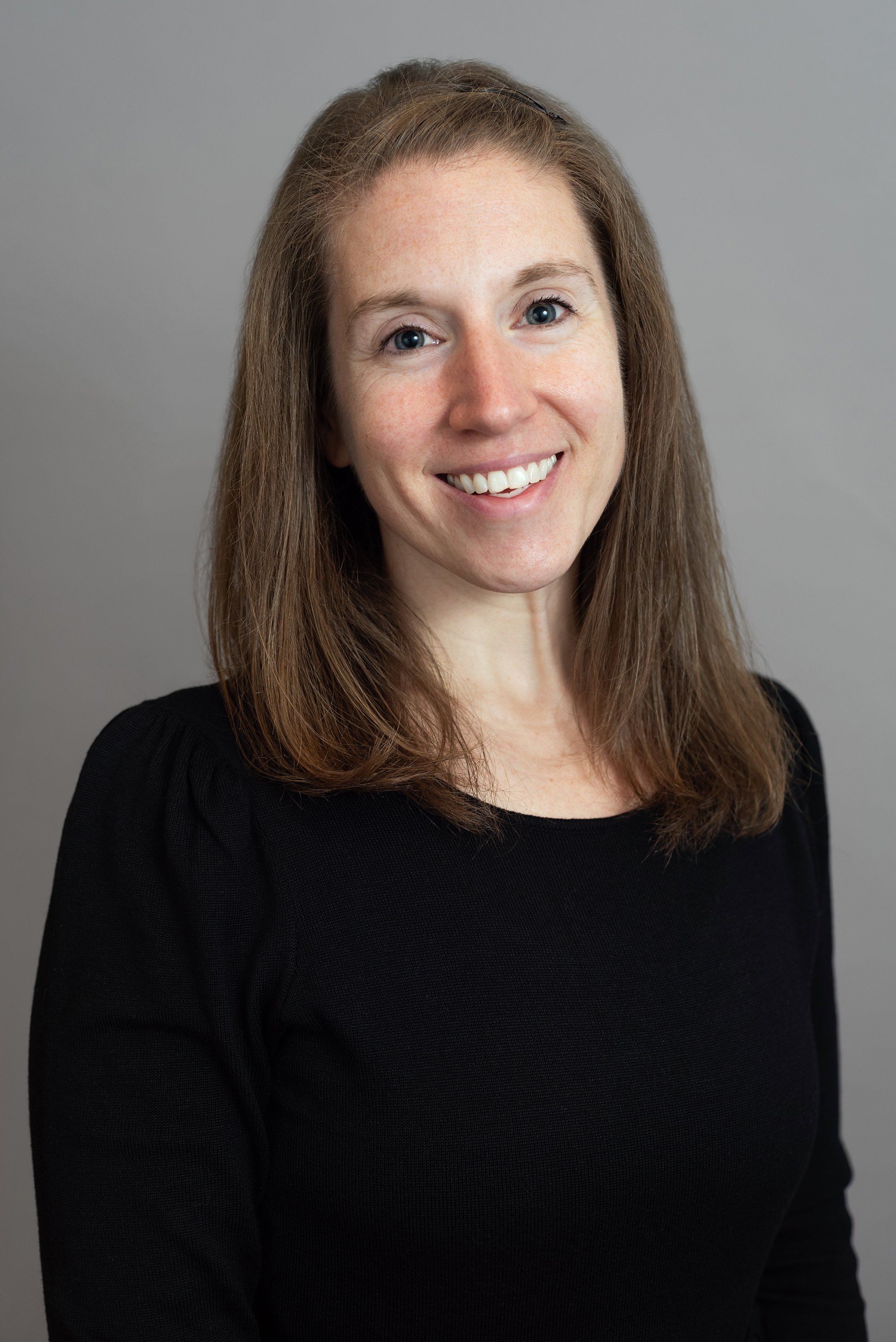  Corporate headshot of woman in a black shirt by Ari Scott, NYC headshot photographer. 