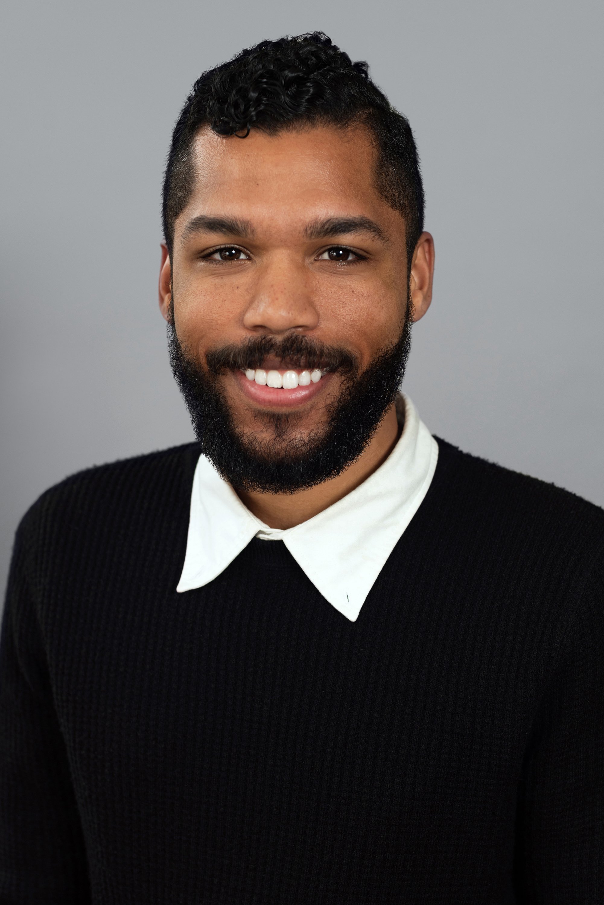  Corporate headshot of man in a black sweater and with a beard by Ari Scott, NYC headshot photographer. 