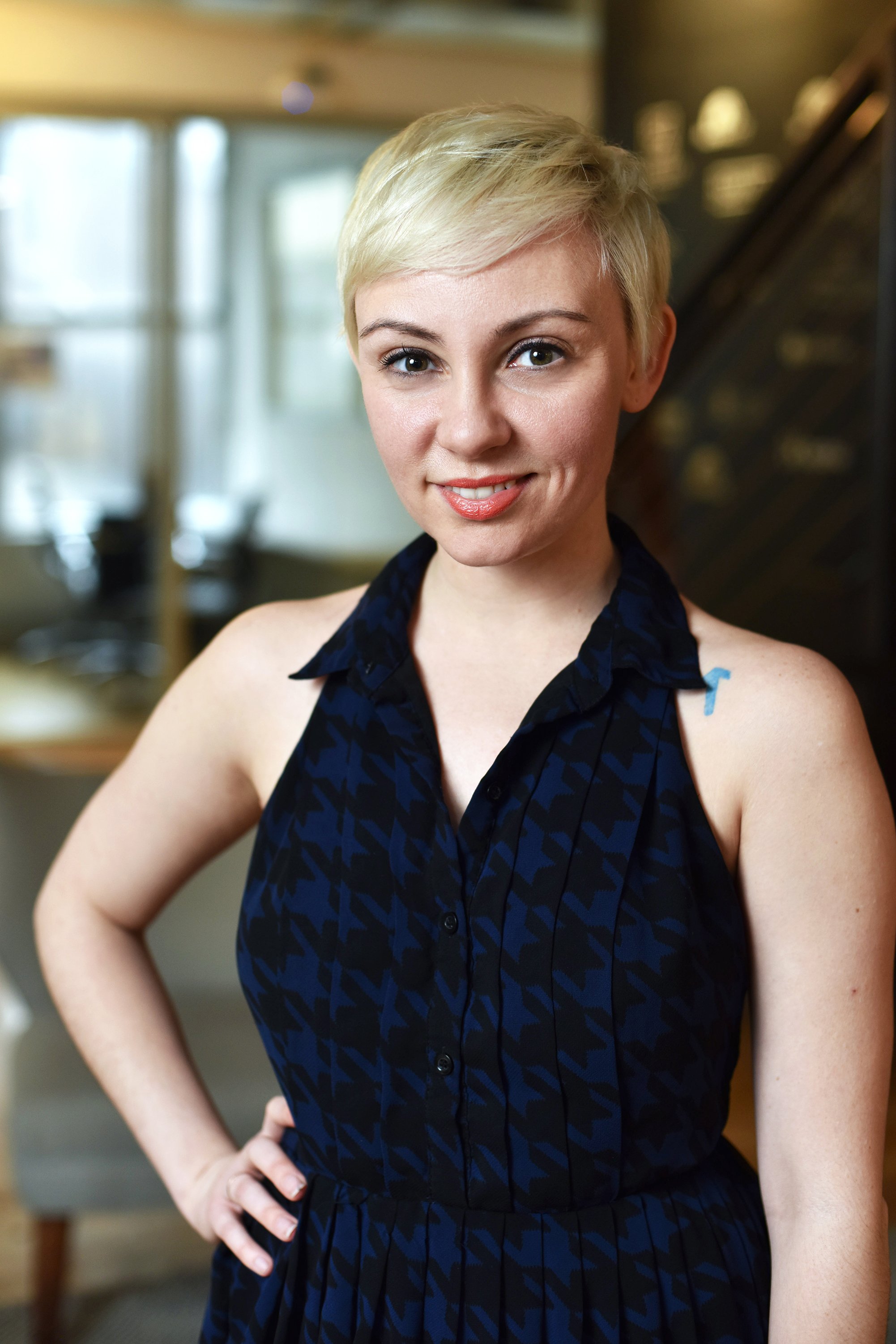 Corporate headshot of a woman in a dark colored checkered dress by Ari Scott, NYC headshot photographer. 