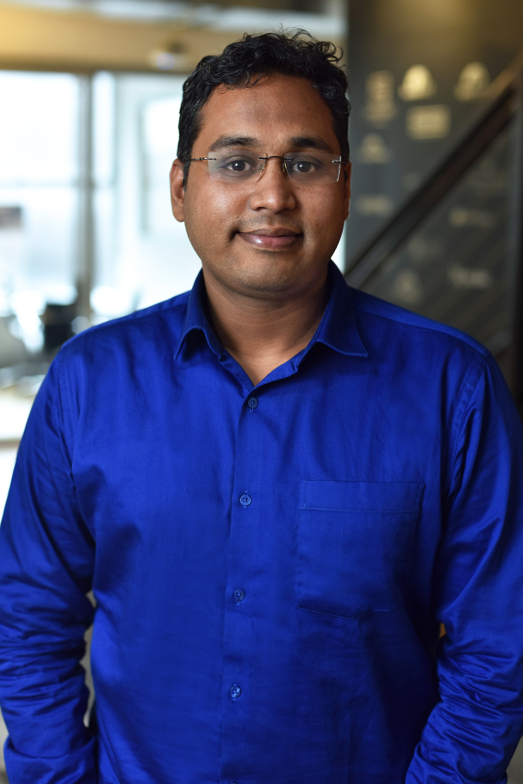  Corporate headshot of a man in a silk blue shirt by Ari Scott, NYC headshot photographer. 