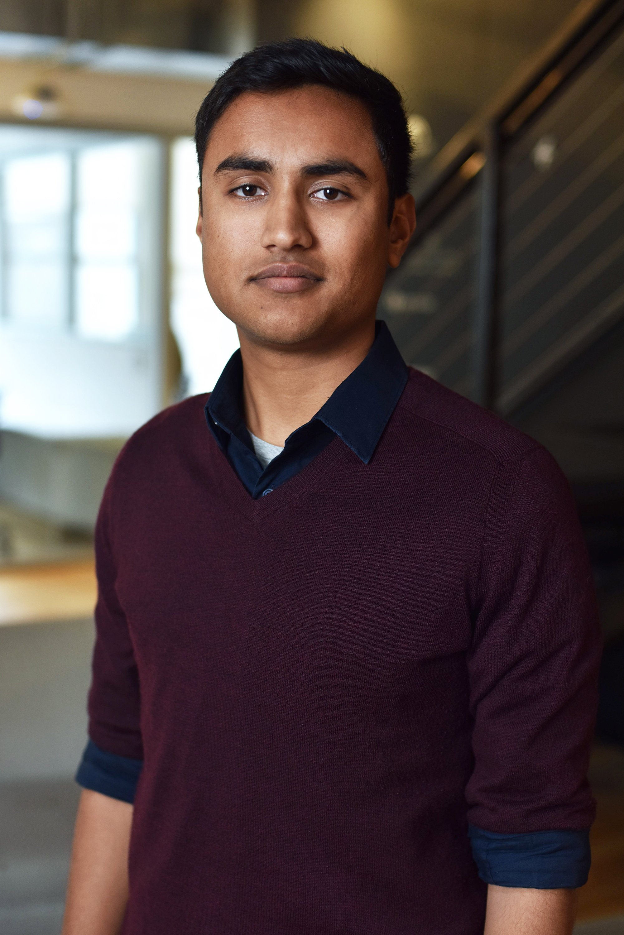  Corporate headshot of a man in a dark red sweater by Ari Scott, NYC headshot photographer. 