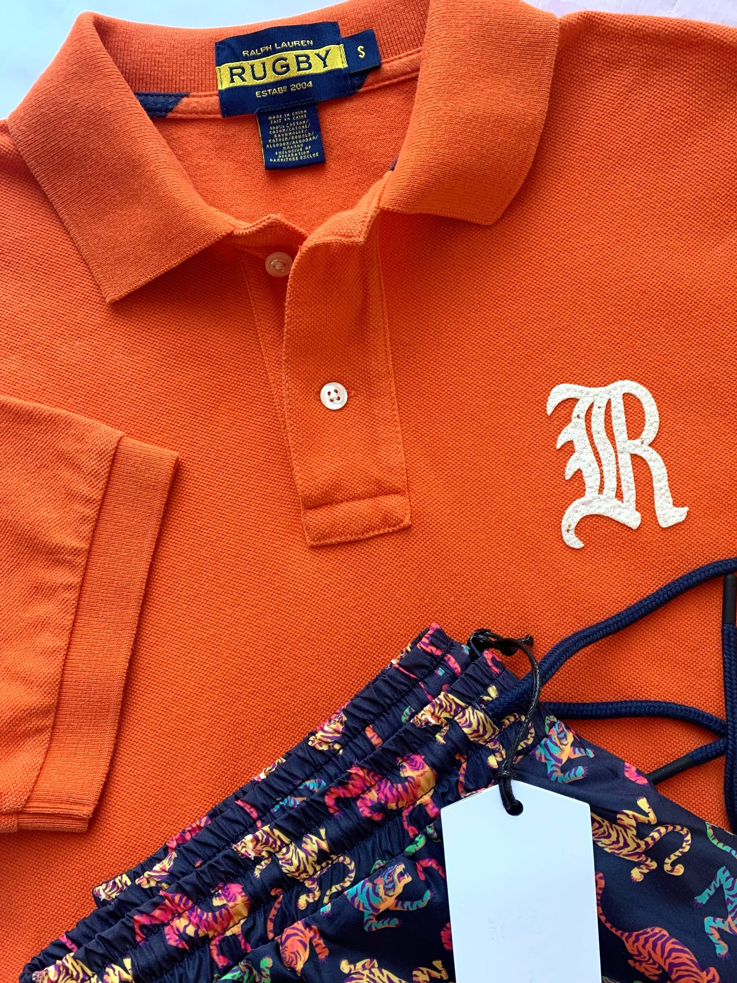Ralph Lauren, from the vintage line Rugby, orange polo style short sleeve shirt, size S; brand new swim trunks from Wesc, size M.
@ralphlauren, @wesc
