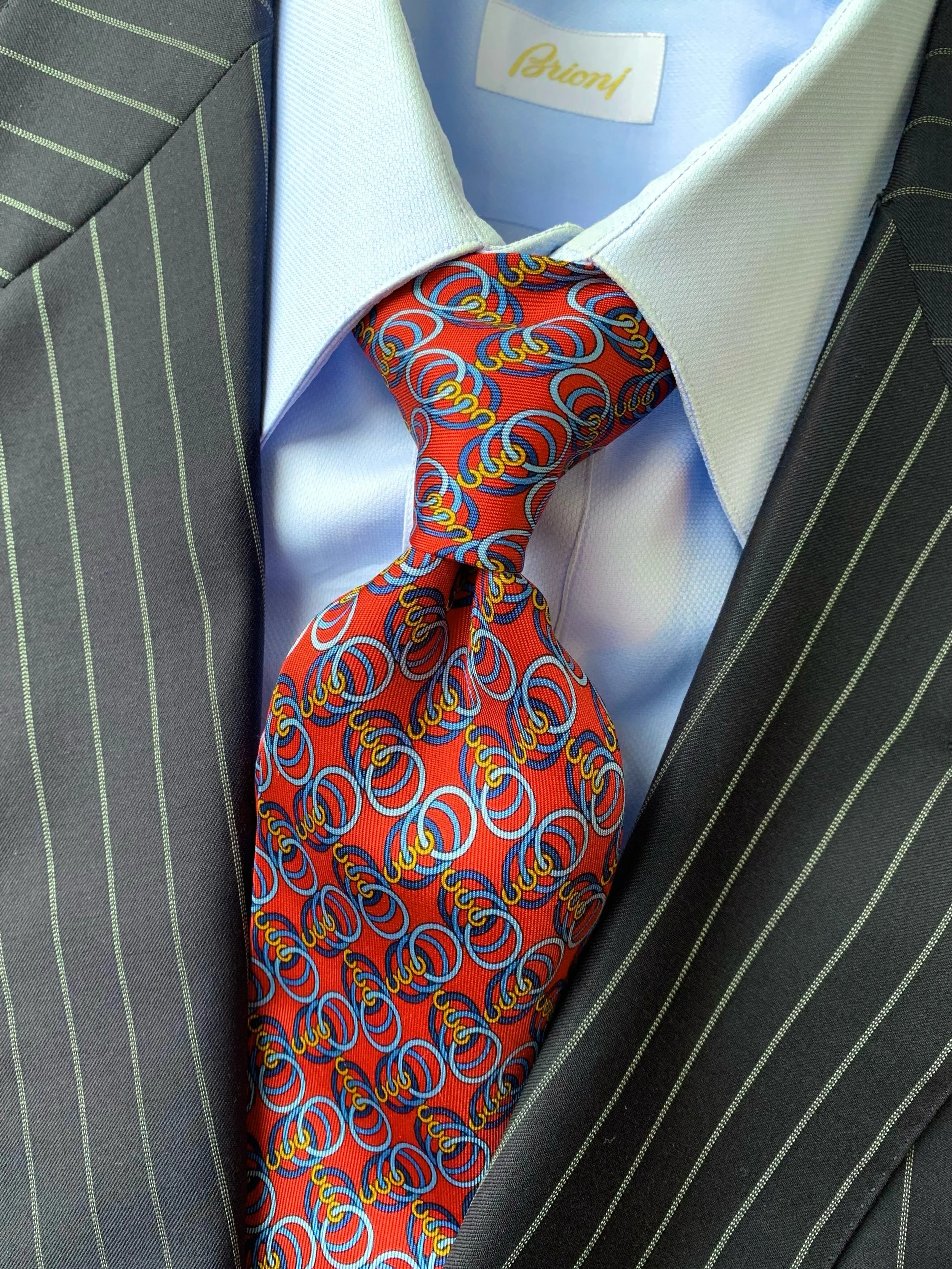 Brioni navy pinstripe suit, size 44L; blue dress shirt from Brioni, size 16.5; necktie from Gucci.
@brioni_official