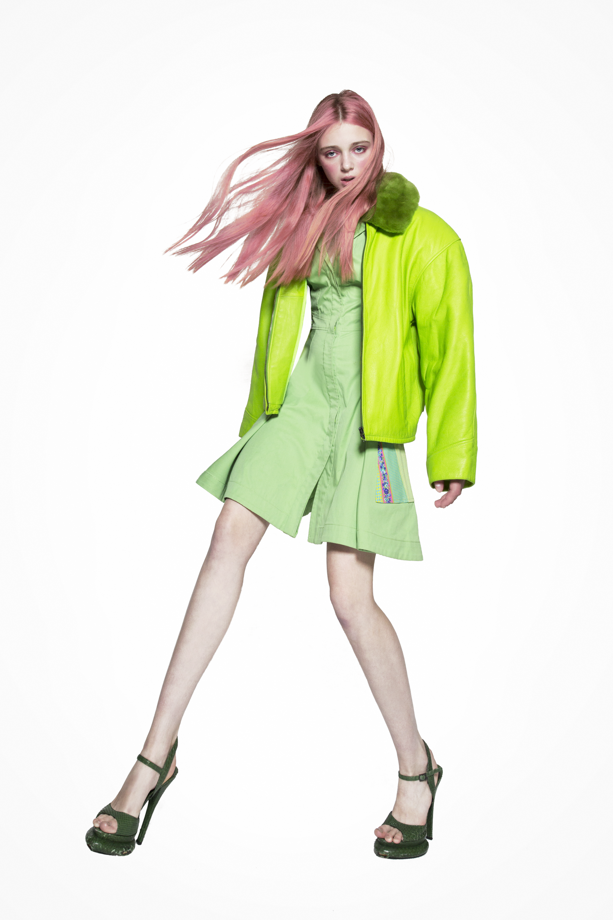 Model in green dress and jacket