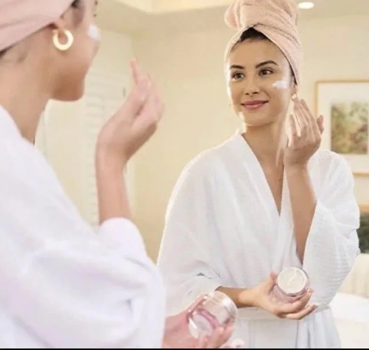 Woman applying nighttime skincare routine for glowing skin