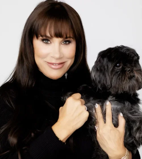 Christina Flach smiling with her dog in a portrait for a podcast interview on grief and healing