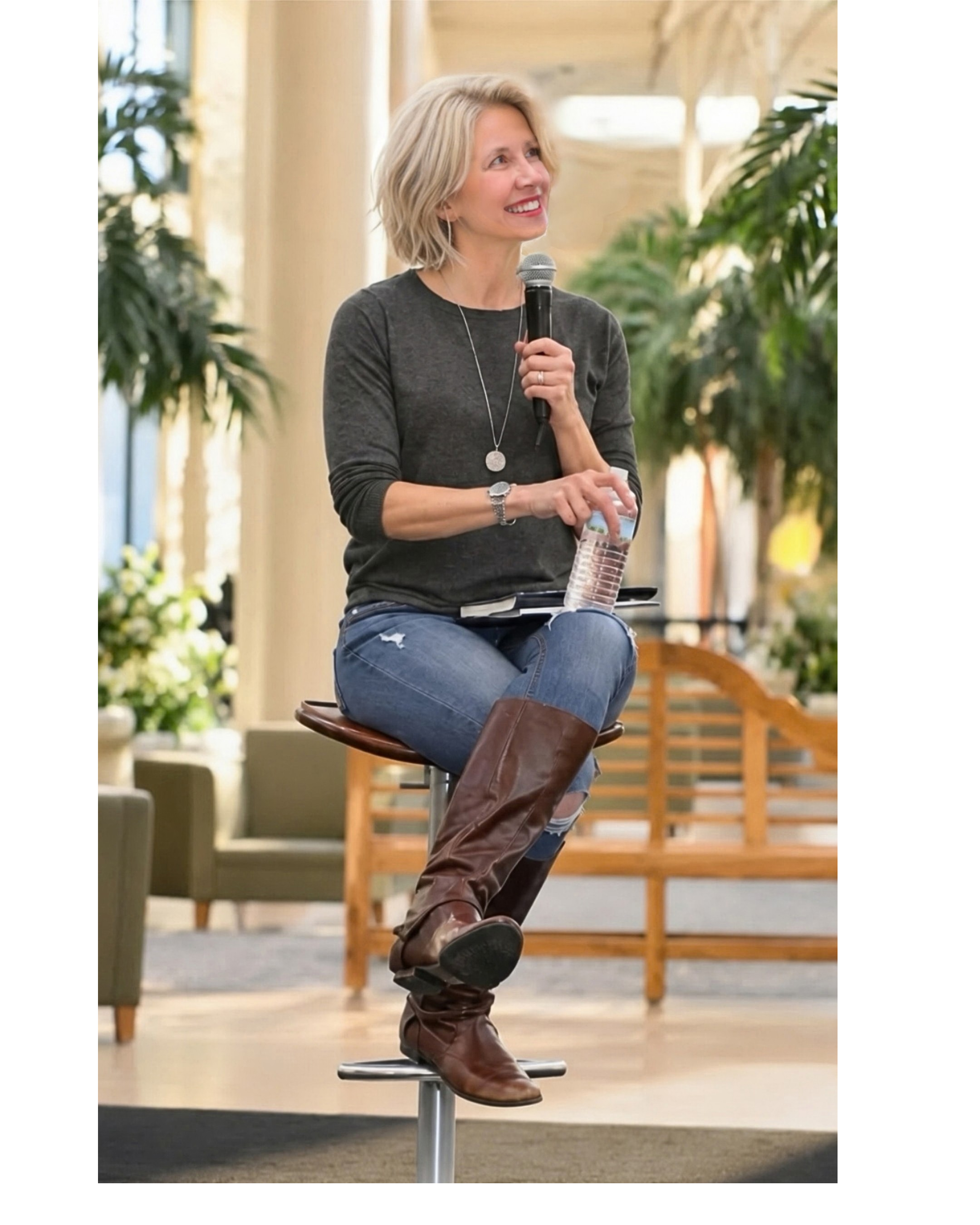 Lauren Myracle seated with a microphone during a speaking engagement.