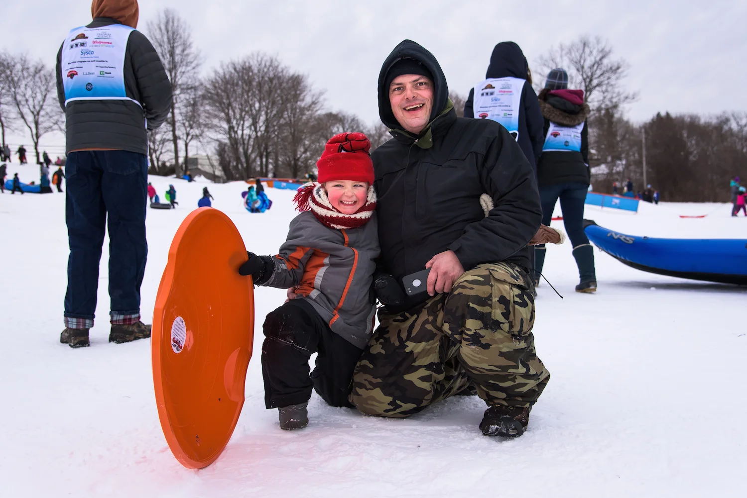 Jason Oliver, Jr., 5, and Jason Oliver, 42, of Westbrook celebrate a successful sled run.