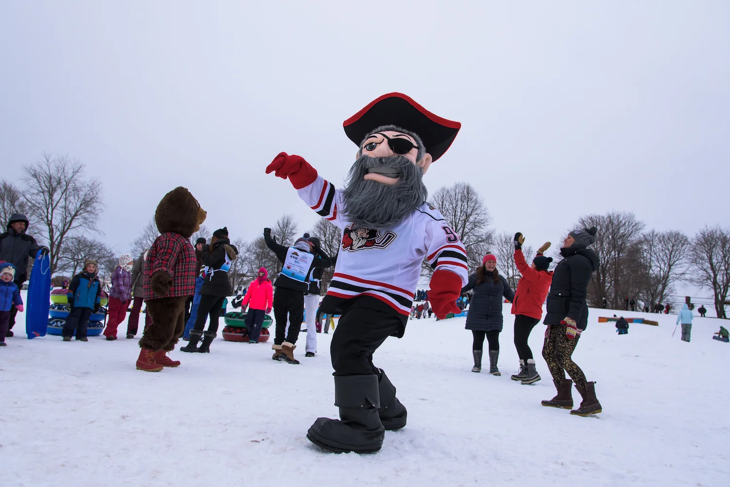 Portland Pirates mascot Salty Pete, L.L.Bear and volunteers from Take Action Portland (TAP) dance in the snow.