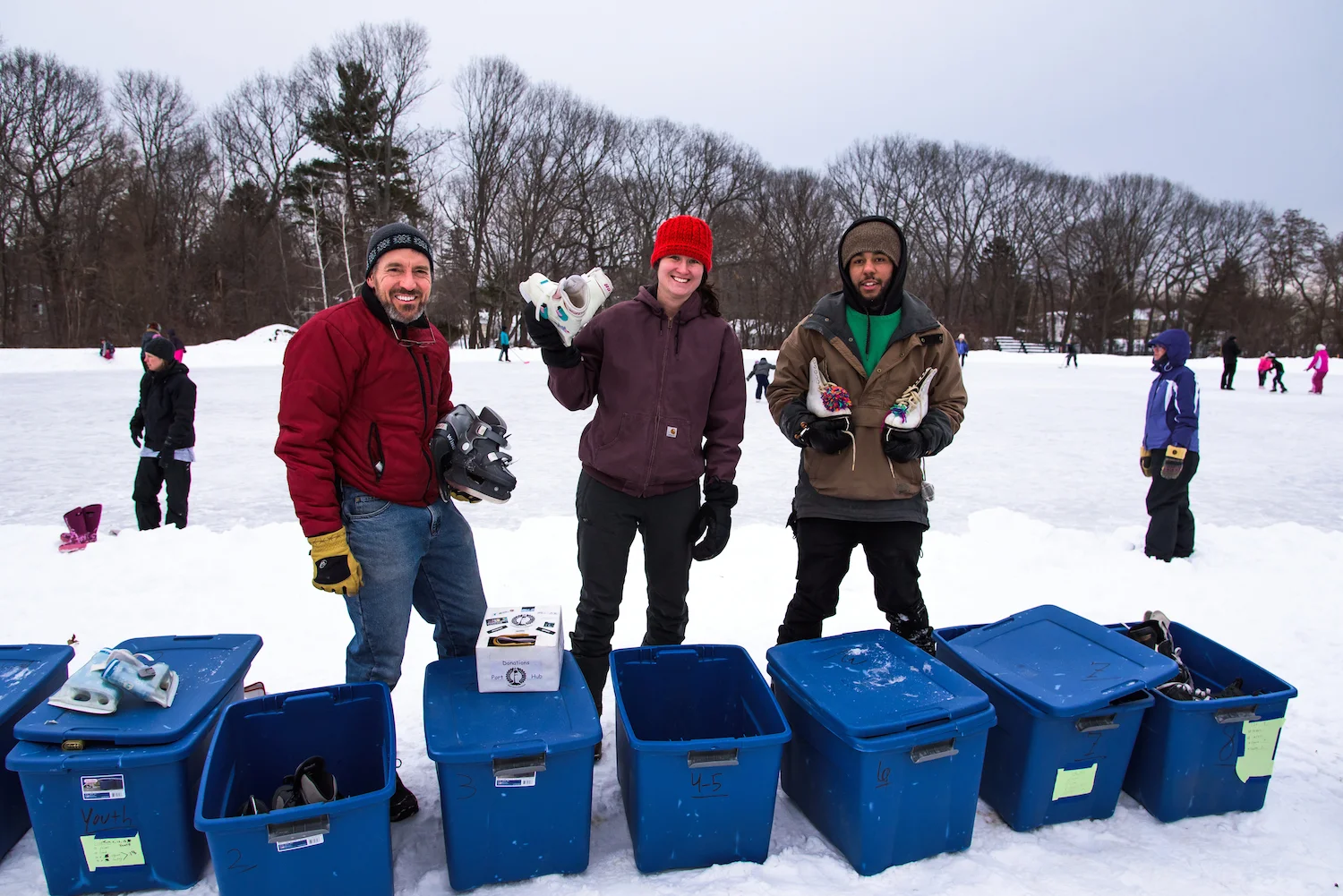 Tom Doherty, Brooke Burkett and Sheldon Lewis of Camp Ketcha in Scarborough lend ice skates to children and families.