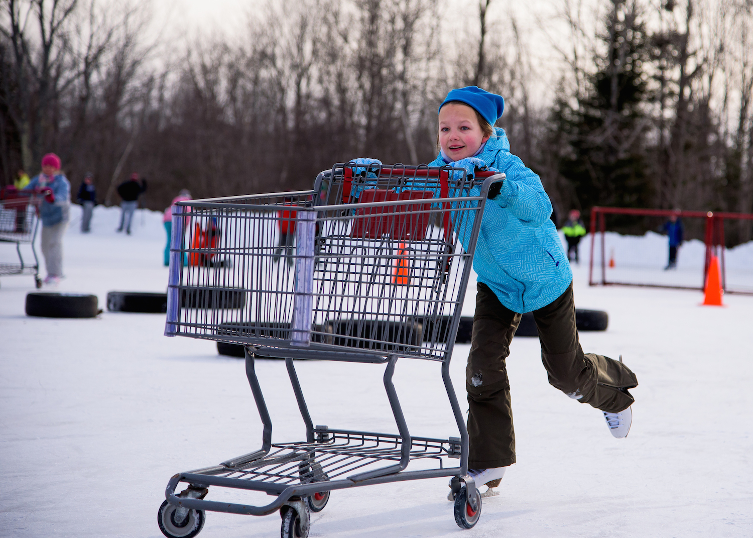 Madelyn Lindsay, 10, of Scarborough pushes a shopping cart through the Obstacle Course.