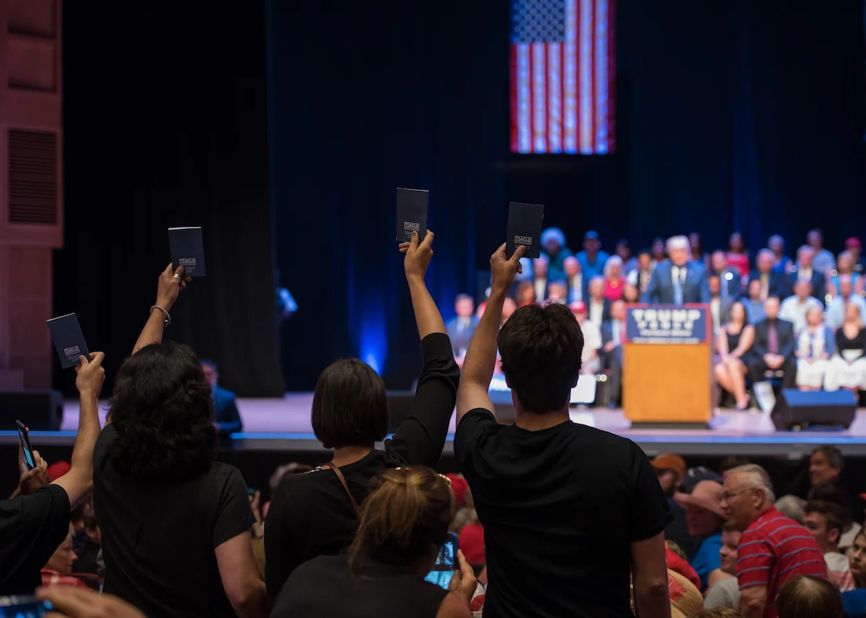 Demonstrators hold up copies of the U.S. Constitution. 