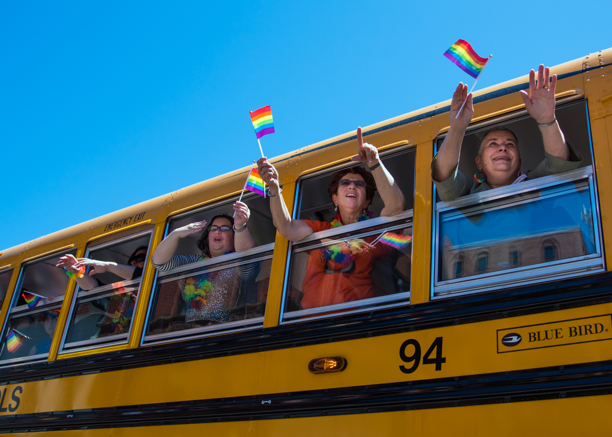 Representatives of Portland Public Schools wave to the crowd on Congress Street from their big yellow school bus at the Portland Pride Parade Saturday, June 18, 2016.