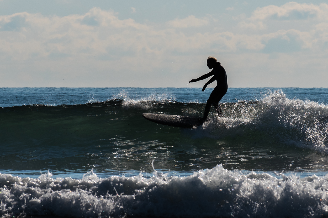 A surfer takes advantage of the relatively balmy temperatures and good waves Tuesday, December 13, 2016 at Higgins Beach in Scarborough.