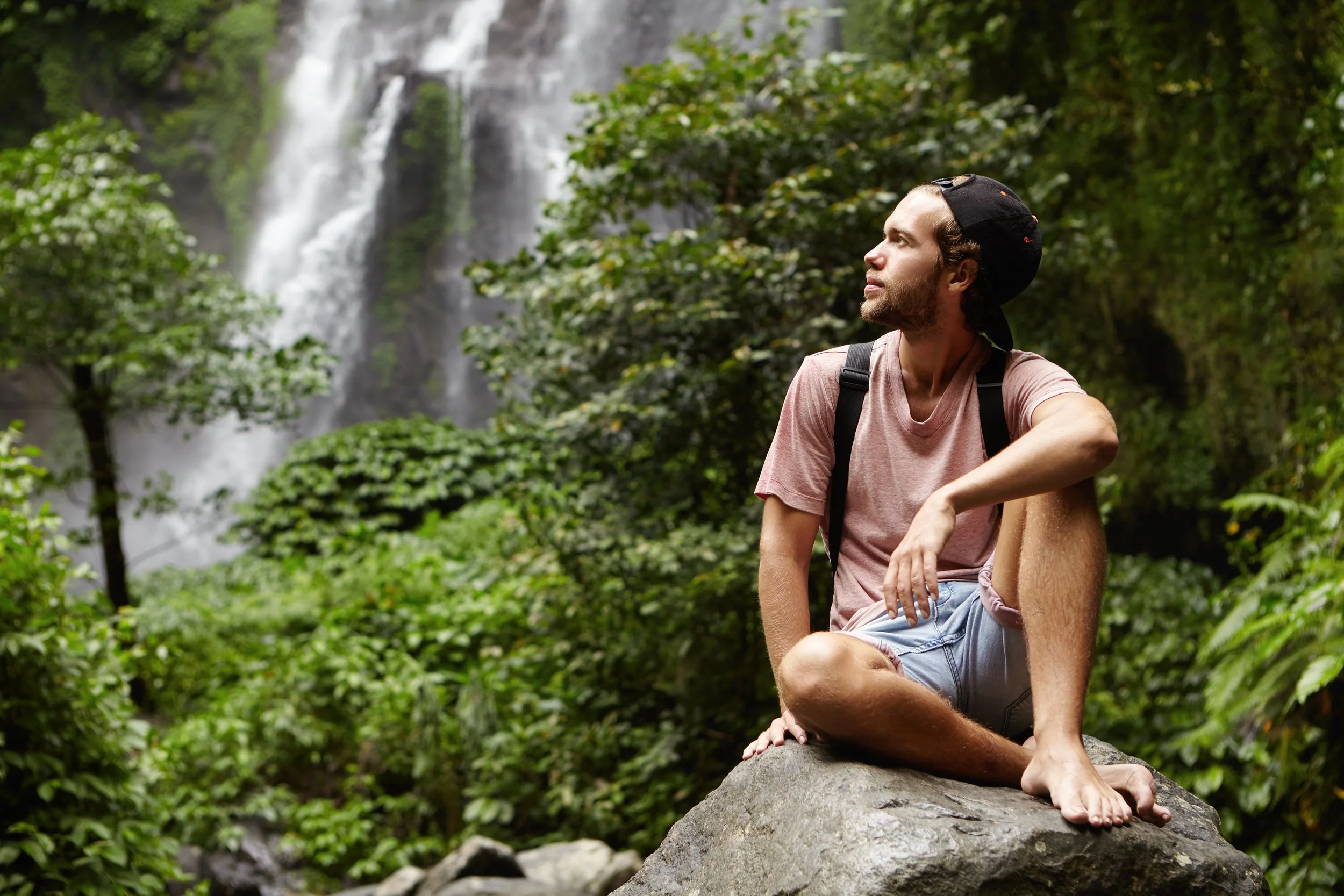 outdoor-shot-handsome-barefooted-young-traveler-with-beard-having-rest-big-rock-his-hiking-trip-rainforest.jpg