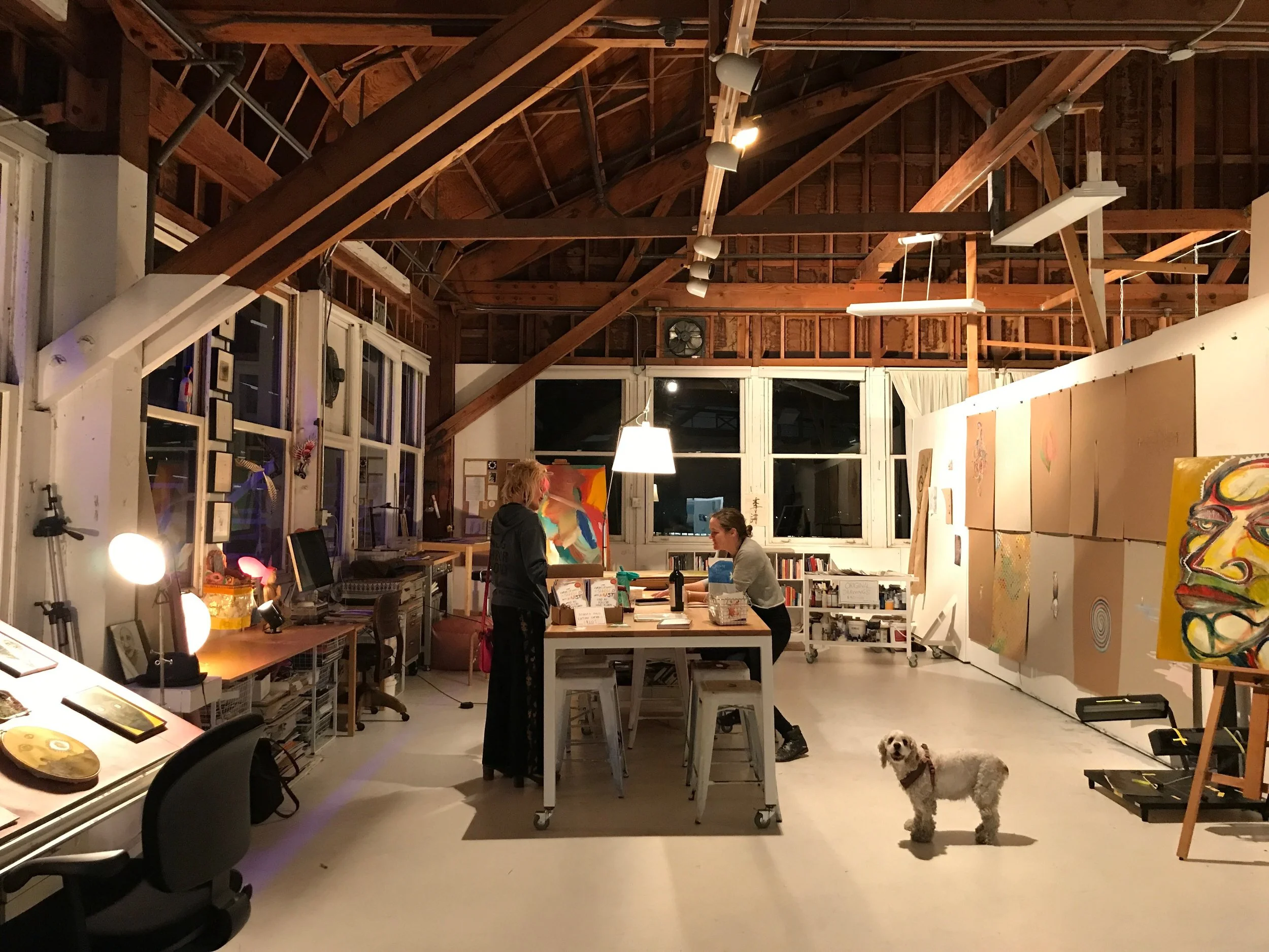 Studio in full bloom during Winter Open Studios. Elle showing her work to a client, with dog Tilly. | December 2017