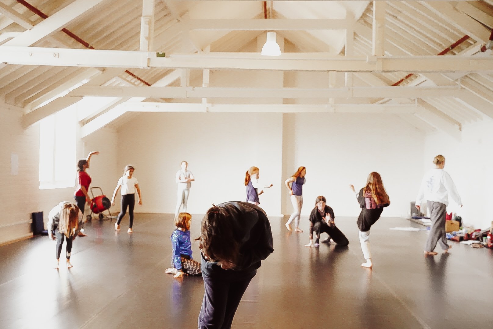 one person in foreground in focus bent over and falling in motion. In the back ground ten bodies are blurred also in motion..jpg