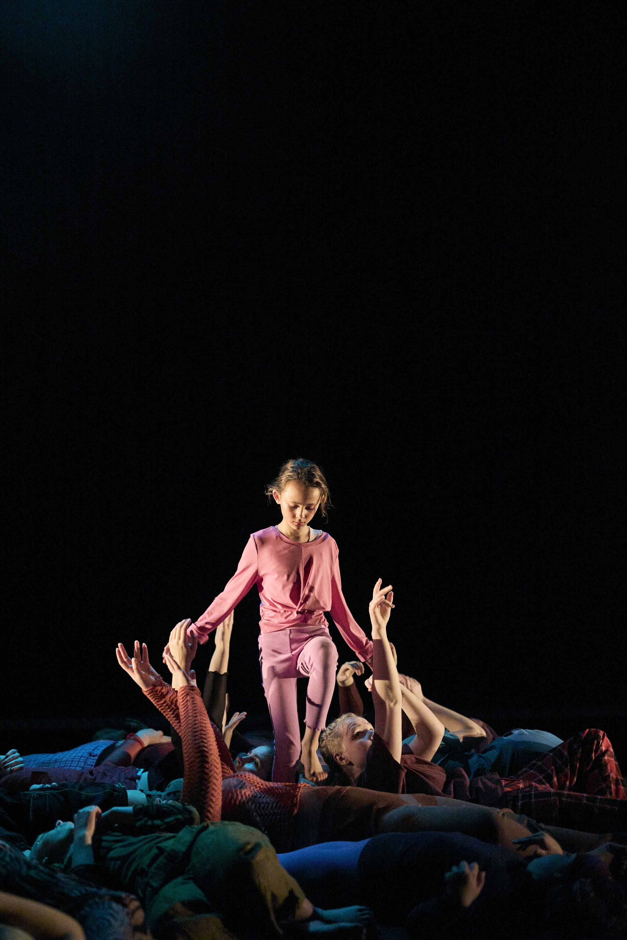 dancer walks through ensemble lying on ground with limbs raised like kelp.jpg