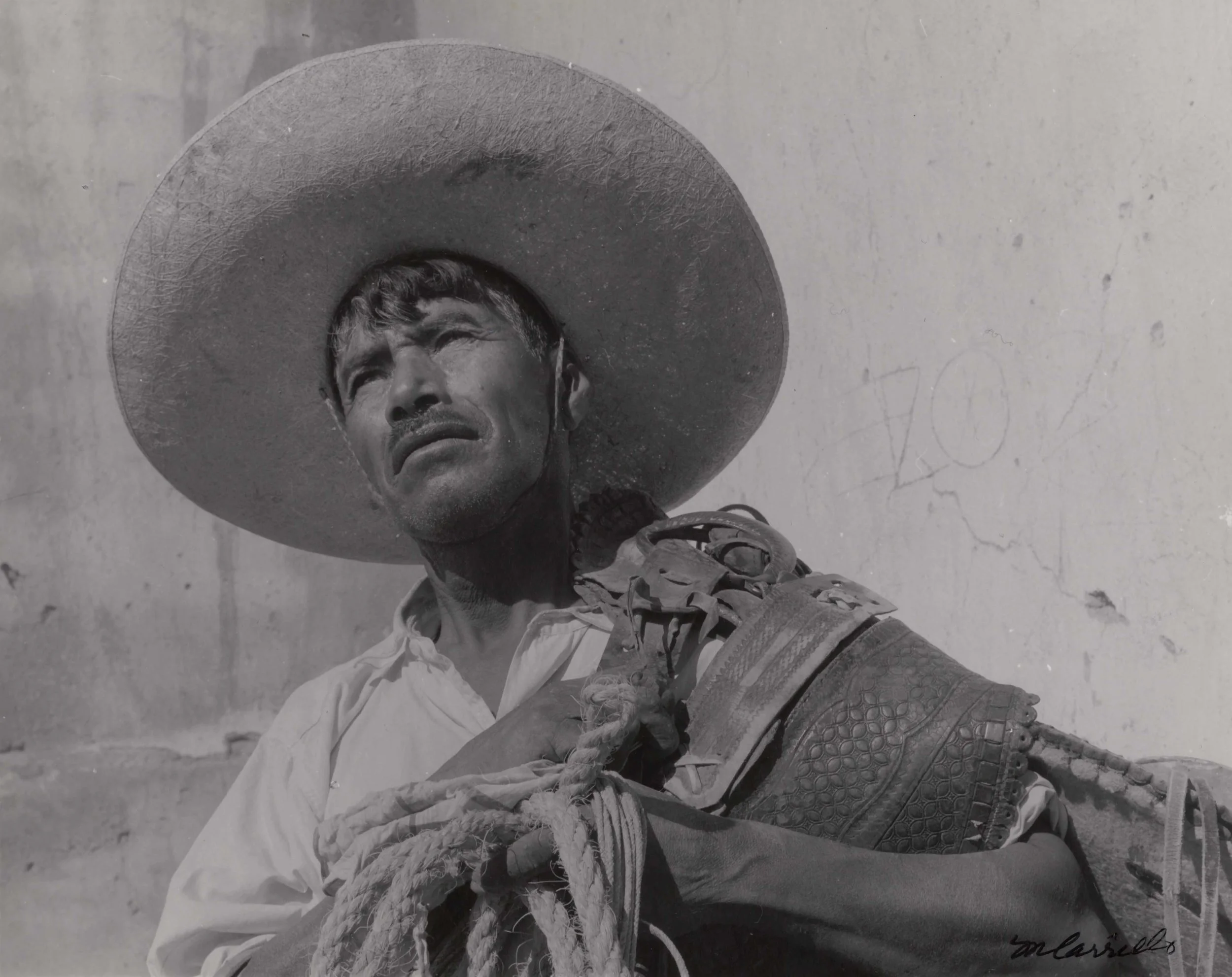 Cowboy with Saddle and Sombrero (Santa Rosa, Guanajuato), 1960. Black & White photograph on paper. 8 x 10