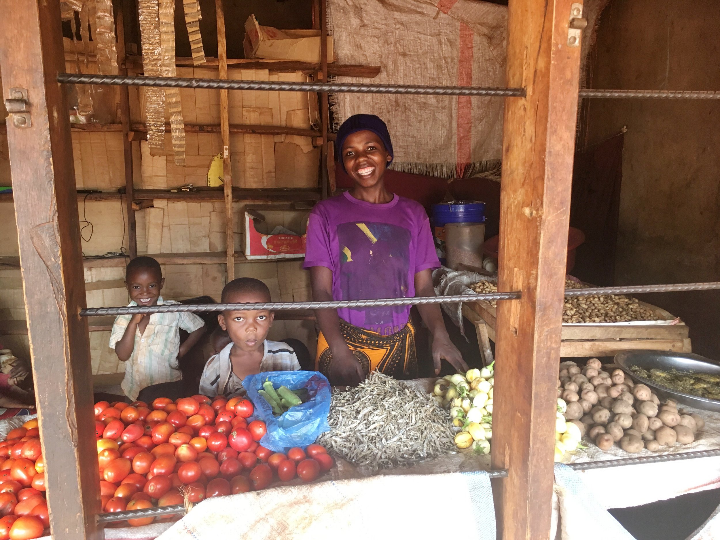Mama Isaya at her shop with her children