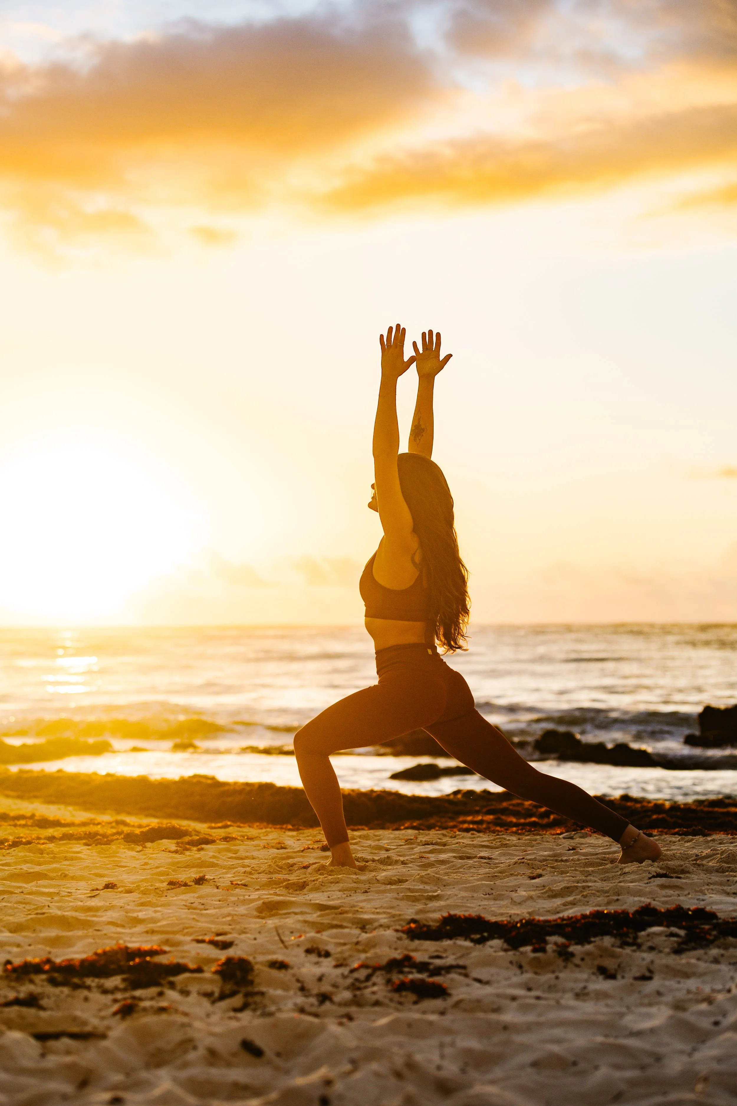 woman on beach doing yoga