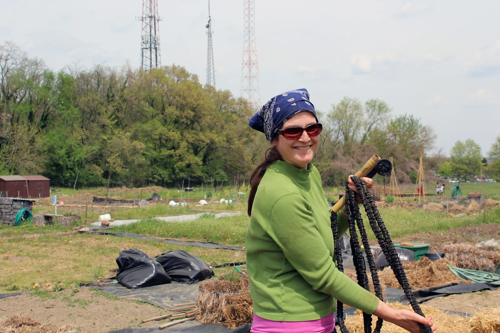 Ingrid Wood, a community garden plot owner at Fort Totten Urban Organic Garden in northeast D.C., waters her 25-by-25 foot garden plot. (Photo by Robin Dienel.)