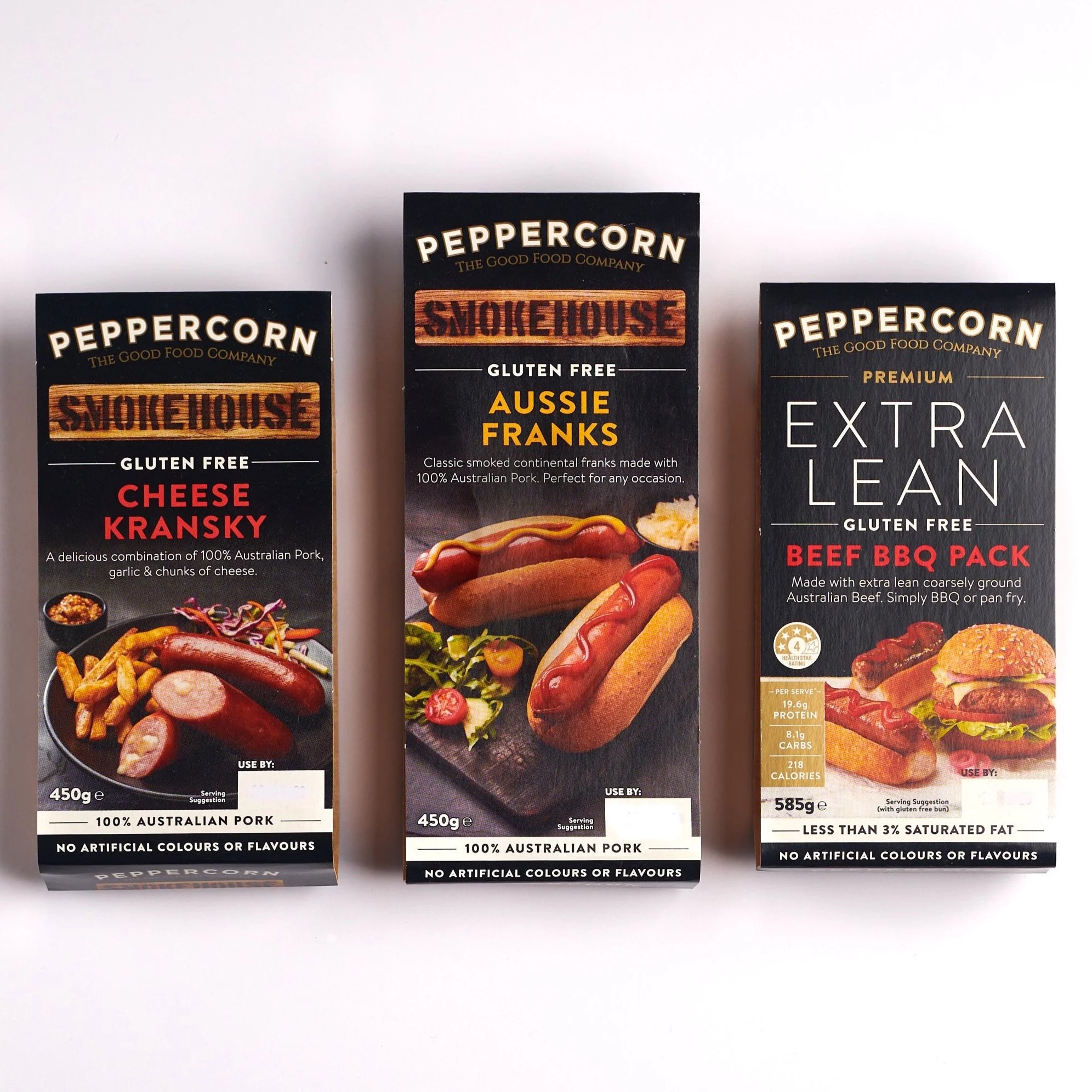 Three packages with images of sausages and hot dogs on the packaging.