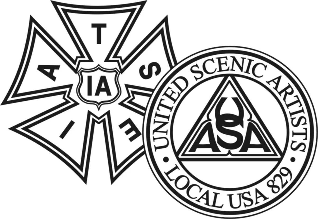 Black and white emblem of the United Scaled Artists local 829, featuring a circular design with the organization's name and a pentagram with the letters ASA and a flame, along with a star-shaped badge with the letters 1A, 1, and 4.