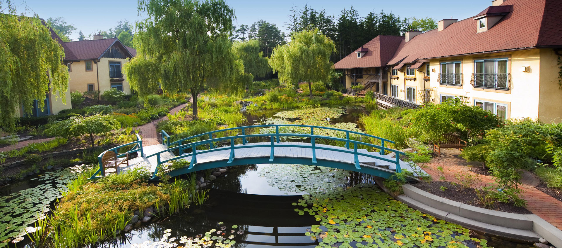 While Mariane Wheatley-Miller designed the planting for this project while working at EDR. This French chateaulike Inn and Spa is located in Skaneateles Village. The Finger Lakes are situated gracefully around the beautiful gardens and ponds, inspired by Claude Monet’s home in Giverny, France. Monet was an avid plant collector, ordering through catalogs, nurseries and friends. In this garden we created planting palettes that echo some of his collections; including, weeping willows and water lilies around the pond, a sampling of peonies, roses, and Irises, and as well as an assortment of colorful perennials.