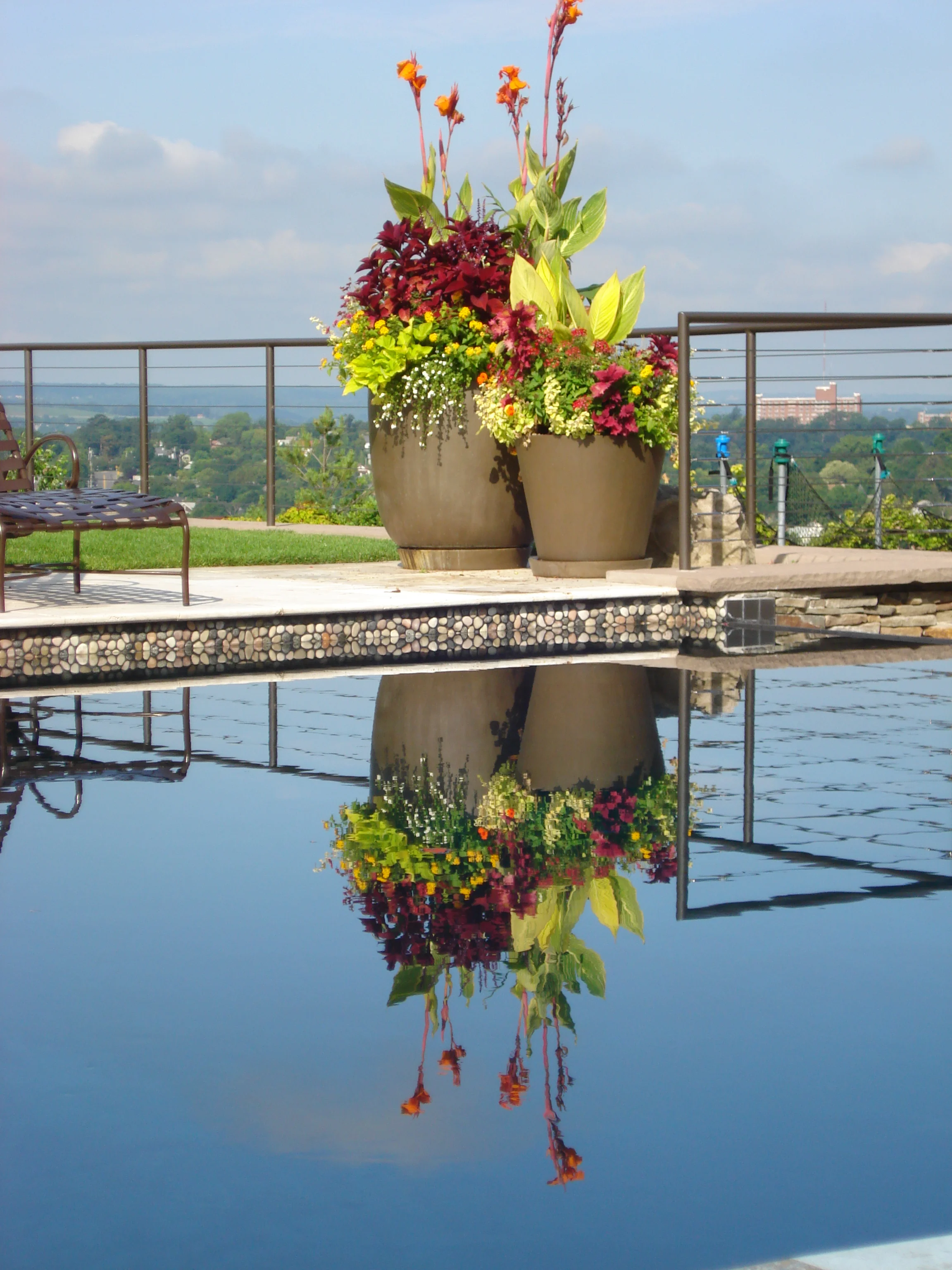  We selected large planters to used throughout the gardens and pool. We selected York and Maverick in the Bronze finish to match the railings power coat. The planters are planted out every spring with a vibrant &amp; dramatic display. The planters ar