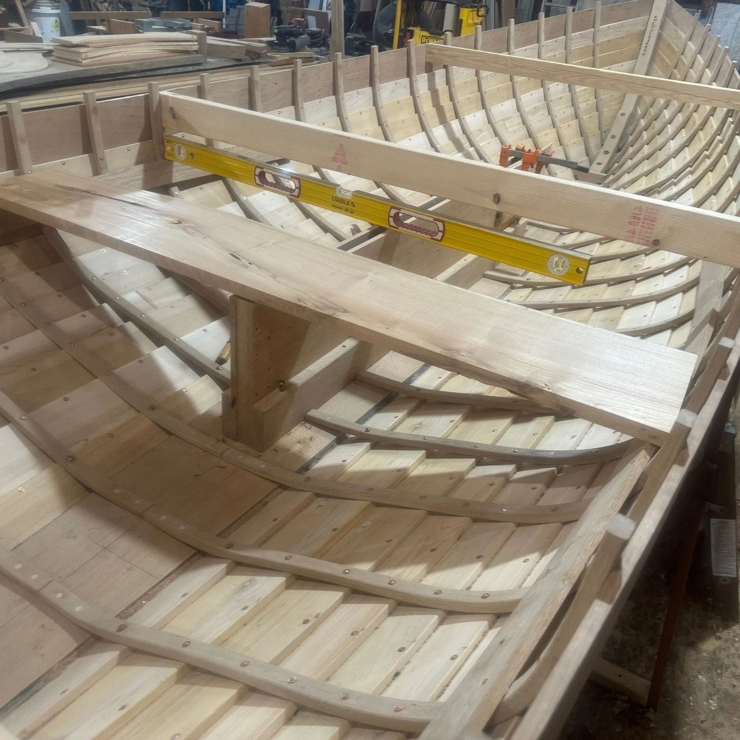 In these photos the centerboard trunk has been fit and temporarily fastened in place. The first photo shows testing the fit of the stern thwart to the top of the trunk. In the next photo, I have fabricated and fit the mast step, and am testing the fi