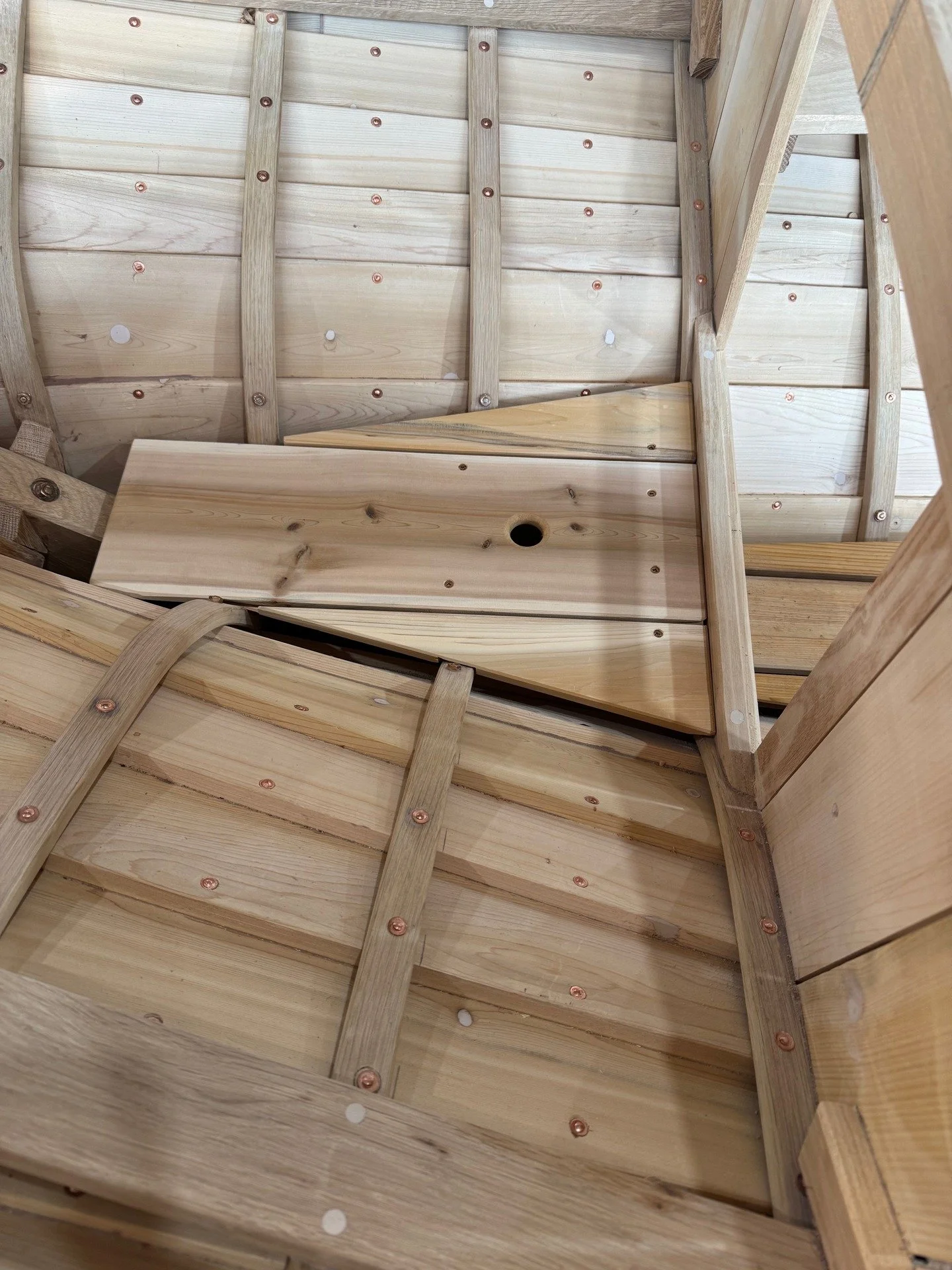 This series shows the aft deck beams. Photo 1 shows the little deck in the aft compartment, it is cedar and removable. Photo 2 shows the locust deck beams being fitted. Photo 3 shows the white oak king beam installed. Photo 4 kind of shows the locust