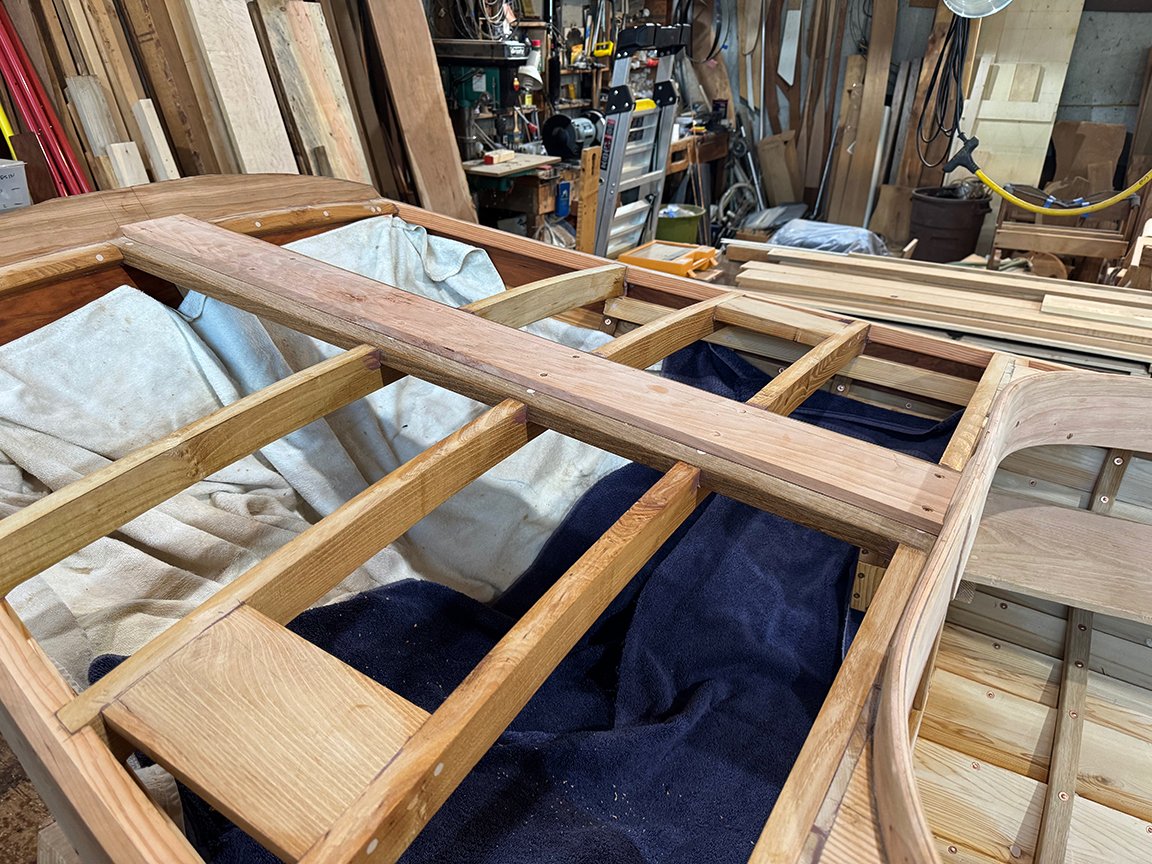 The next step in the construction of the NTS was the deck. The first photo shows the cherry king plank installed at the stern, and the second is the same at the bow. Third photo shows the cedar decking being installed aft. the spaces between the plan