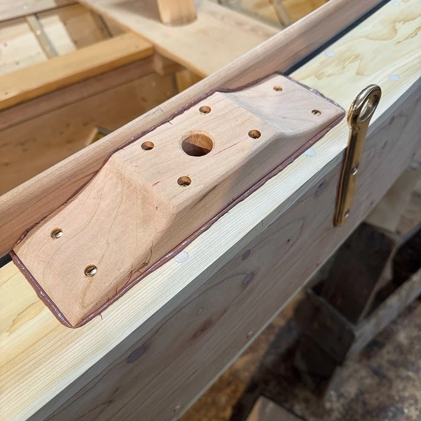 More progress- the cherry oarlock blocks are being installed. Photo 1 shows the forward single oarlock installed outside the coaming, along with the bronze chainplate. Photo 2 shows the aft block with 2 holes, the forward one for the stand up oarlock
