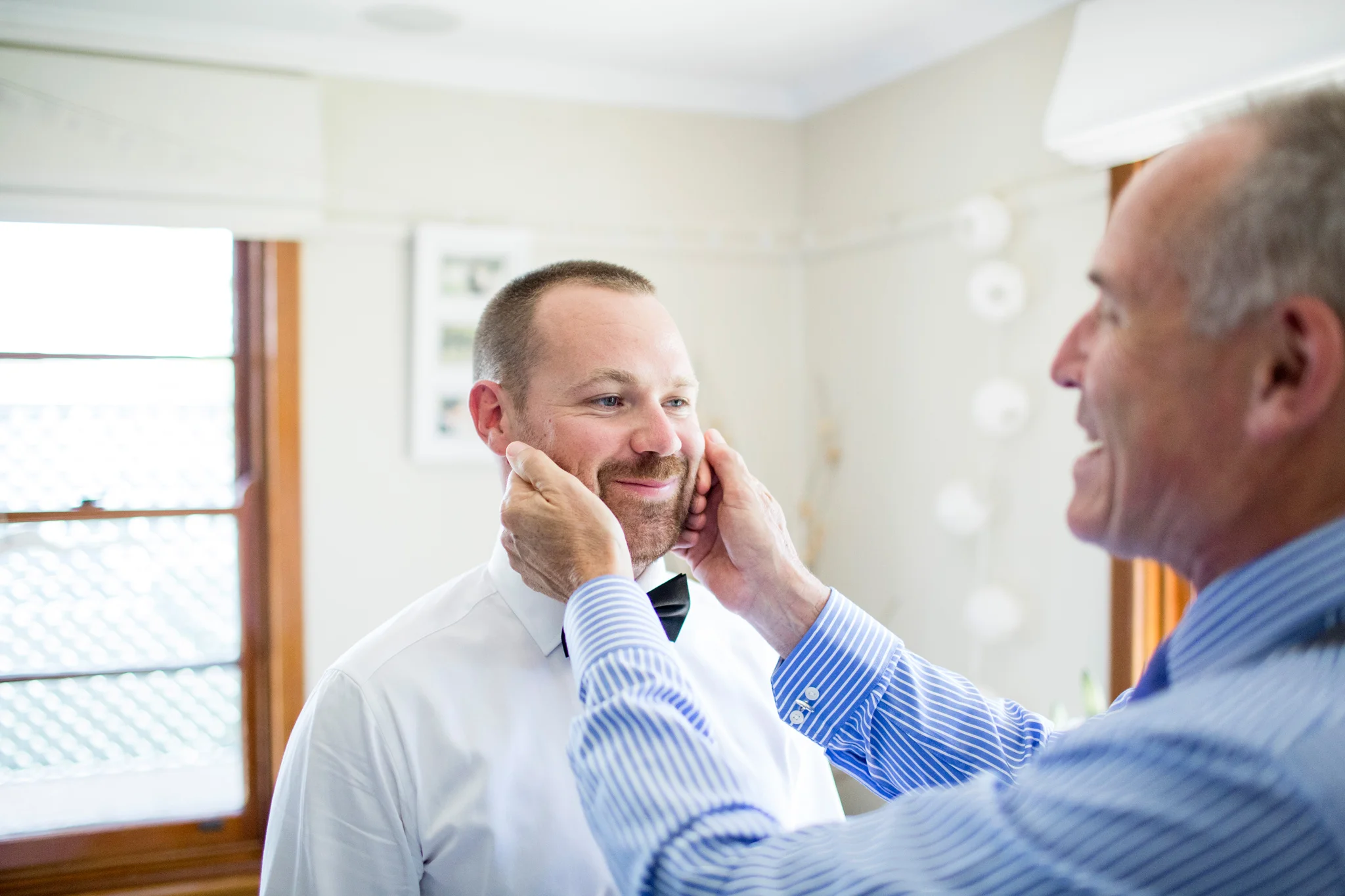 Groom's father gives his son words of encouragement before his wedding at Grazing at Gundaroo.