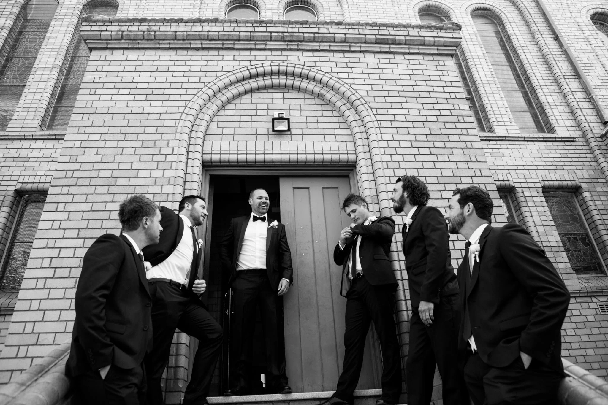 Groom and his groomsmen outside St Christopher's Cathedral Manuka.