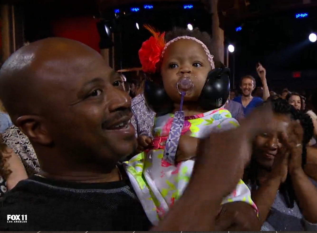 La'Porsha Renae's daughter, with action-figure-Alexander on her shoulder