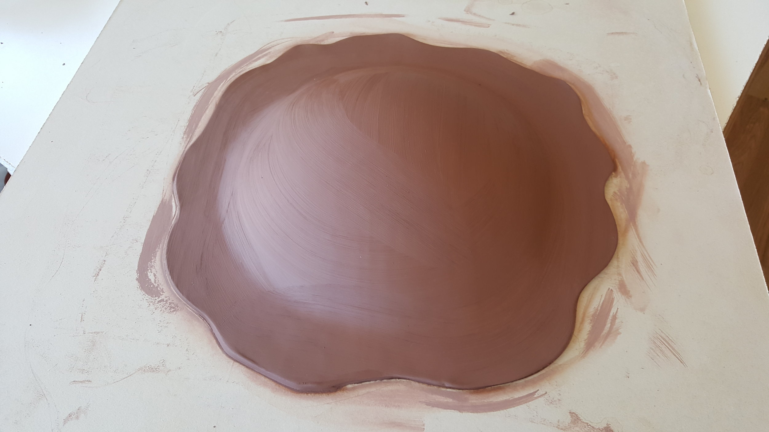 Clay is formed around a plaster cast and shape cut around the form.