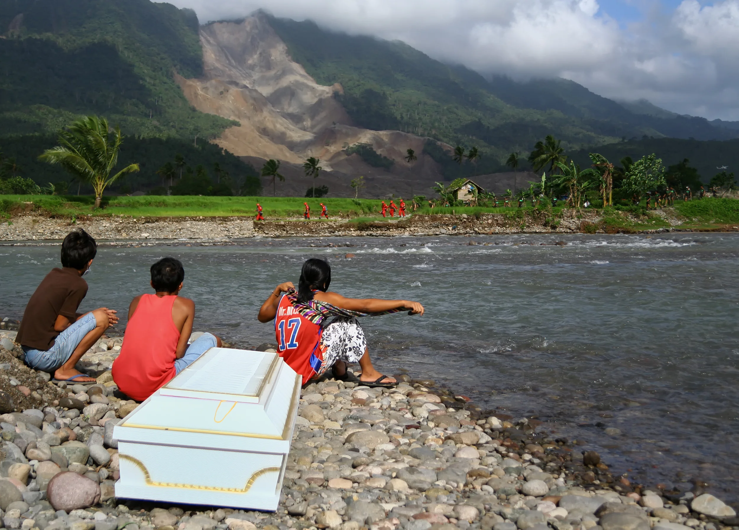 Awaiting the arrival of a family member killed in a landslide on the island of Leyte, Philippines.