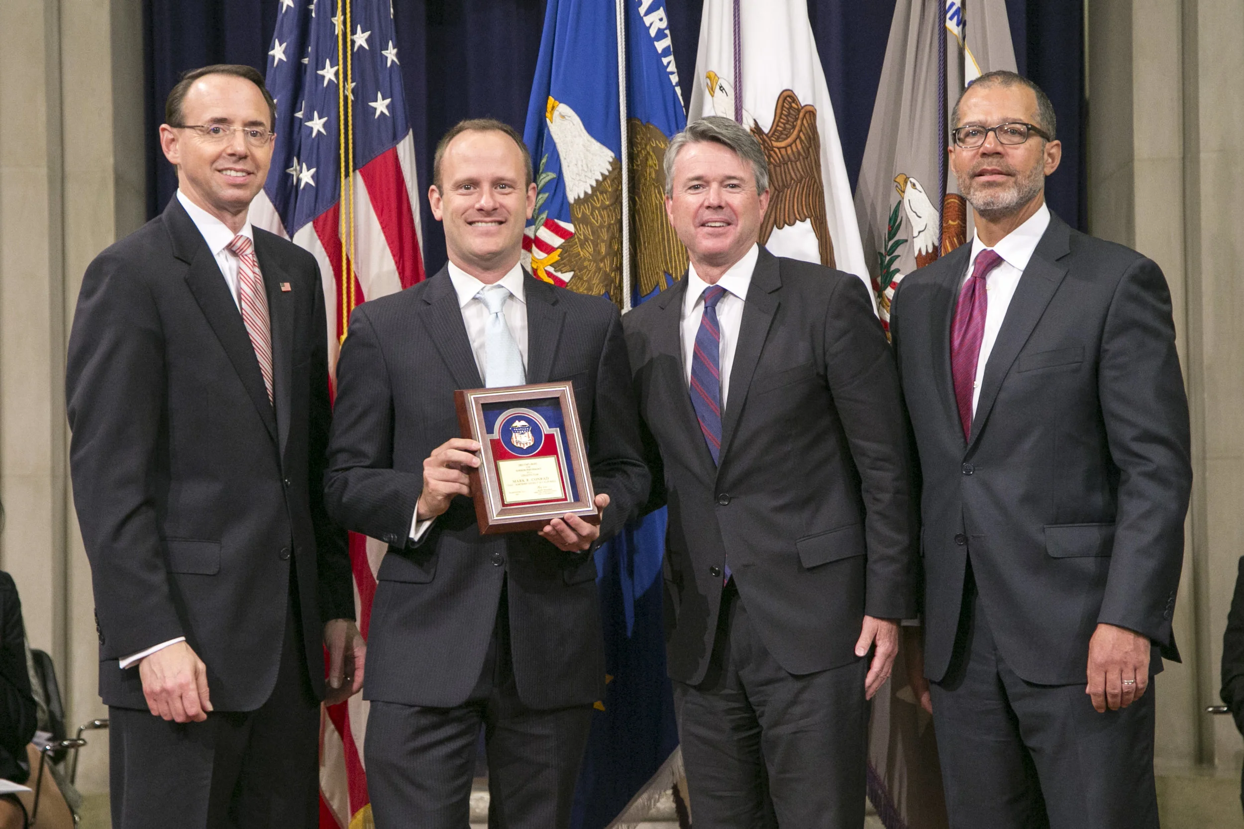 From left: Rod Rosenstein, Deputy Attorney General; Mark Conrad; Brian Stretch, U.S. Attorney for the Northern District of California; Monty Wilkinson, Director of the Executive Office for United States Attorneys 