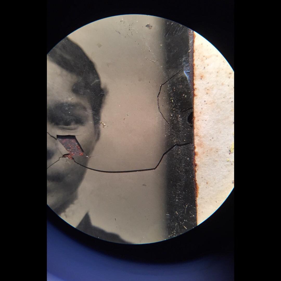 // Tintype - photographic conservation // A tintype under magnification showing the cracked collodian emulsion / image layer. Experimenting with tannic acid to treat corrosion of the iron support prior to consolidating the collodian photographic laye