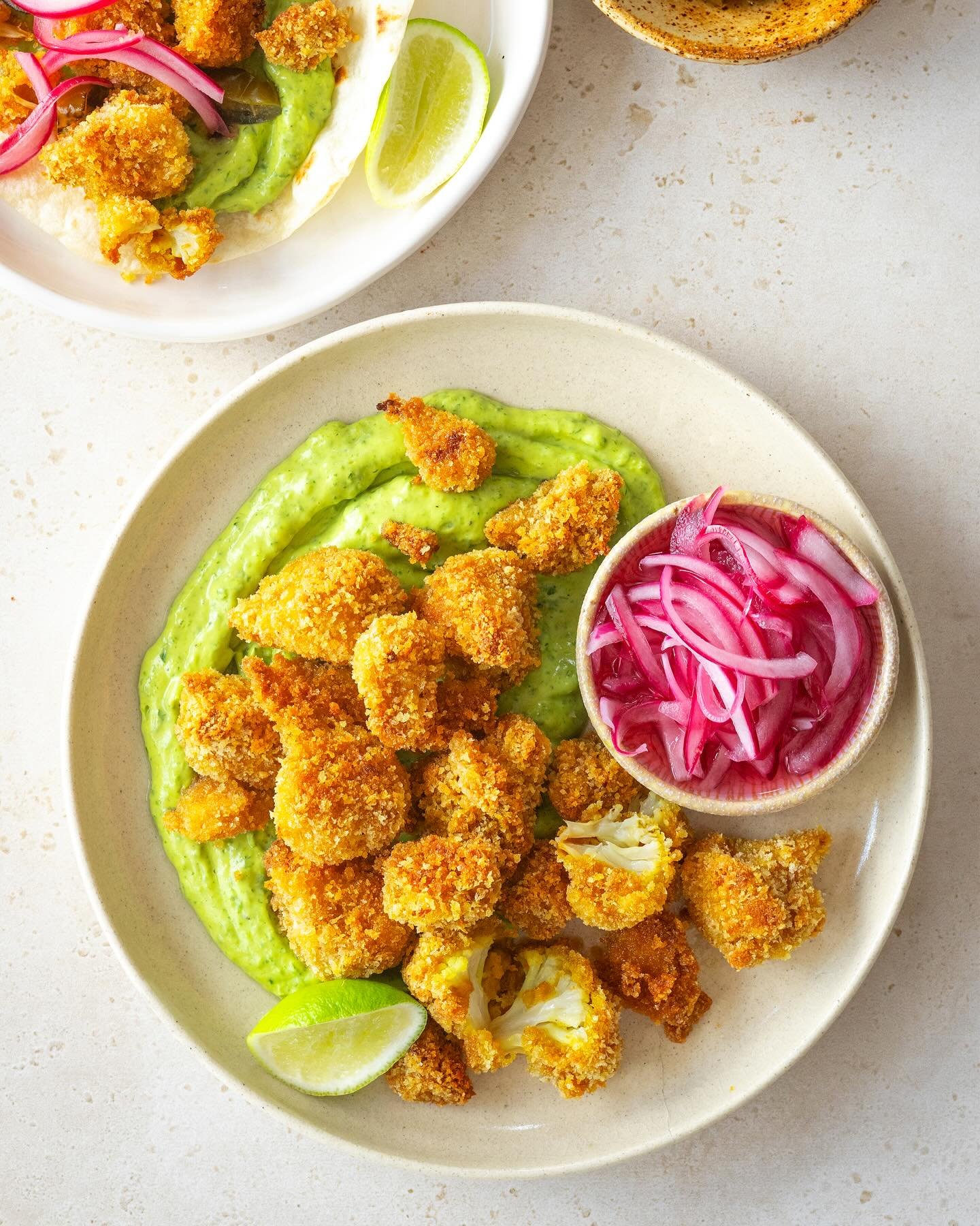 Crunchy cauliflower bites with quick pickled onions and coriander and avo dip! These bites are SO yummy. Eat them as nibbles or pop them in tacos or a salad. I have the pickiest kids and even they like these (they haven&rsquo;t worked out it&rsquo;s 