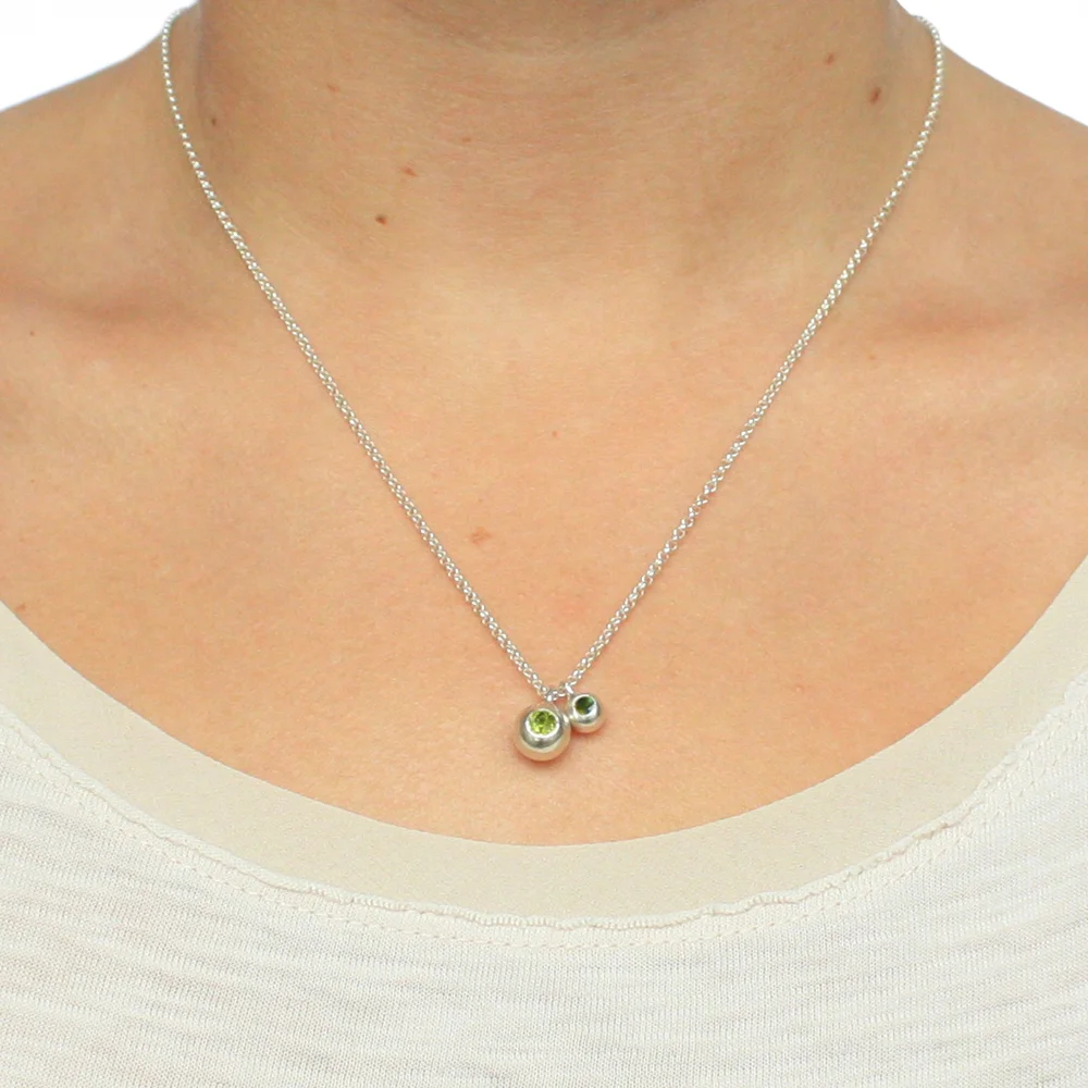 Double Orb Necklace with green stones Body 2.jpg
