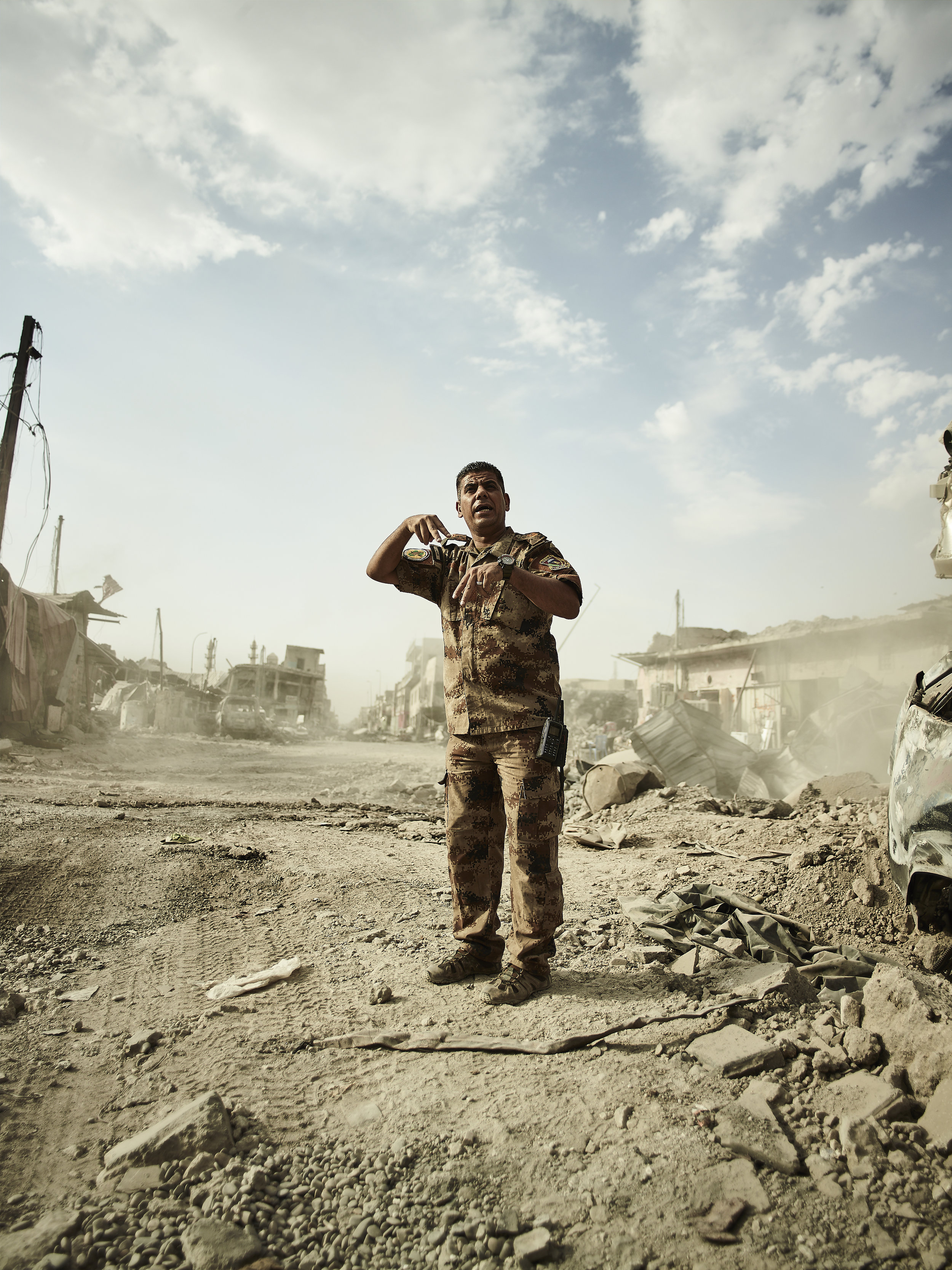 An Iraqi army major ordering the removal of rubble, West Mosul