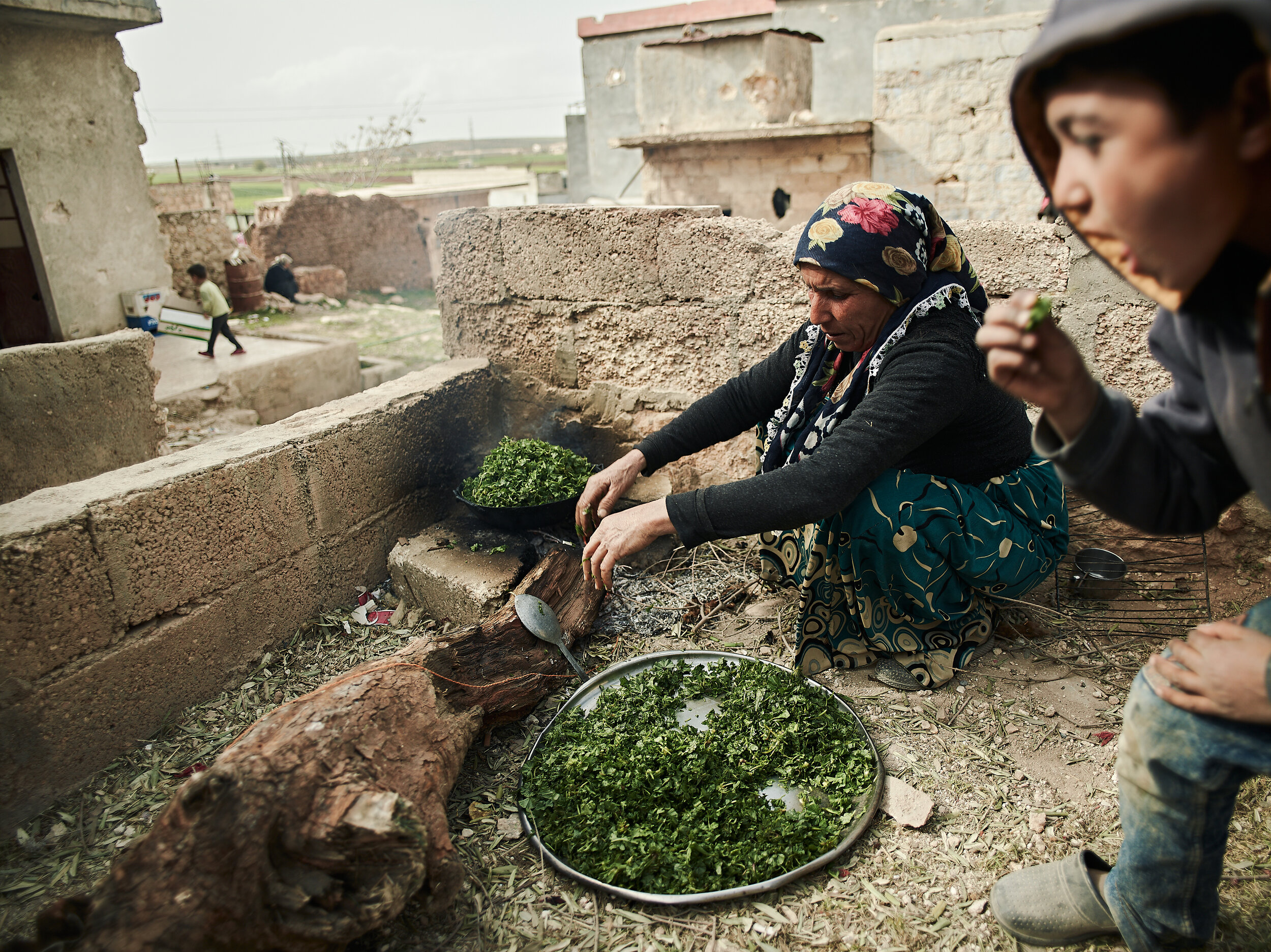 Refugees from Afrin cooking food in their new home, which was previously occupied by ISIS