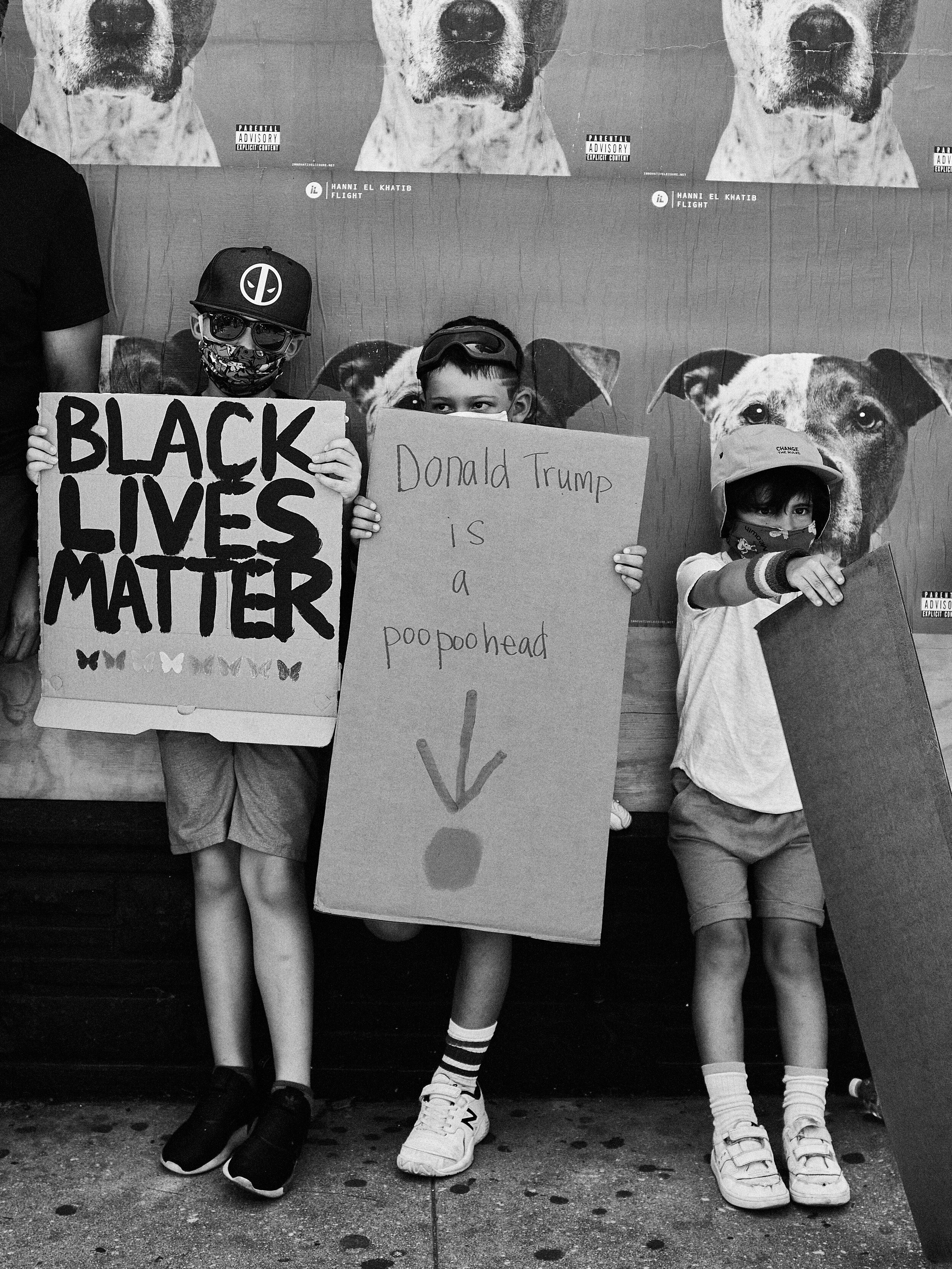 Young protestors hold up signs during the Pride x BLM Parade, Los Angeles