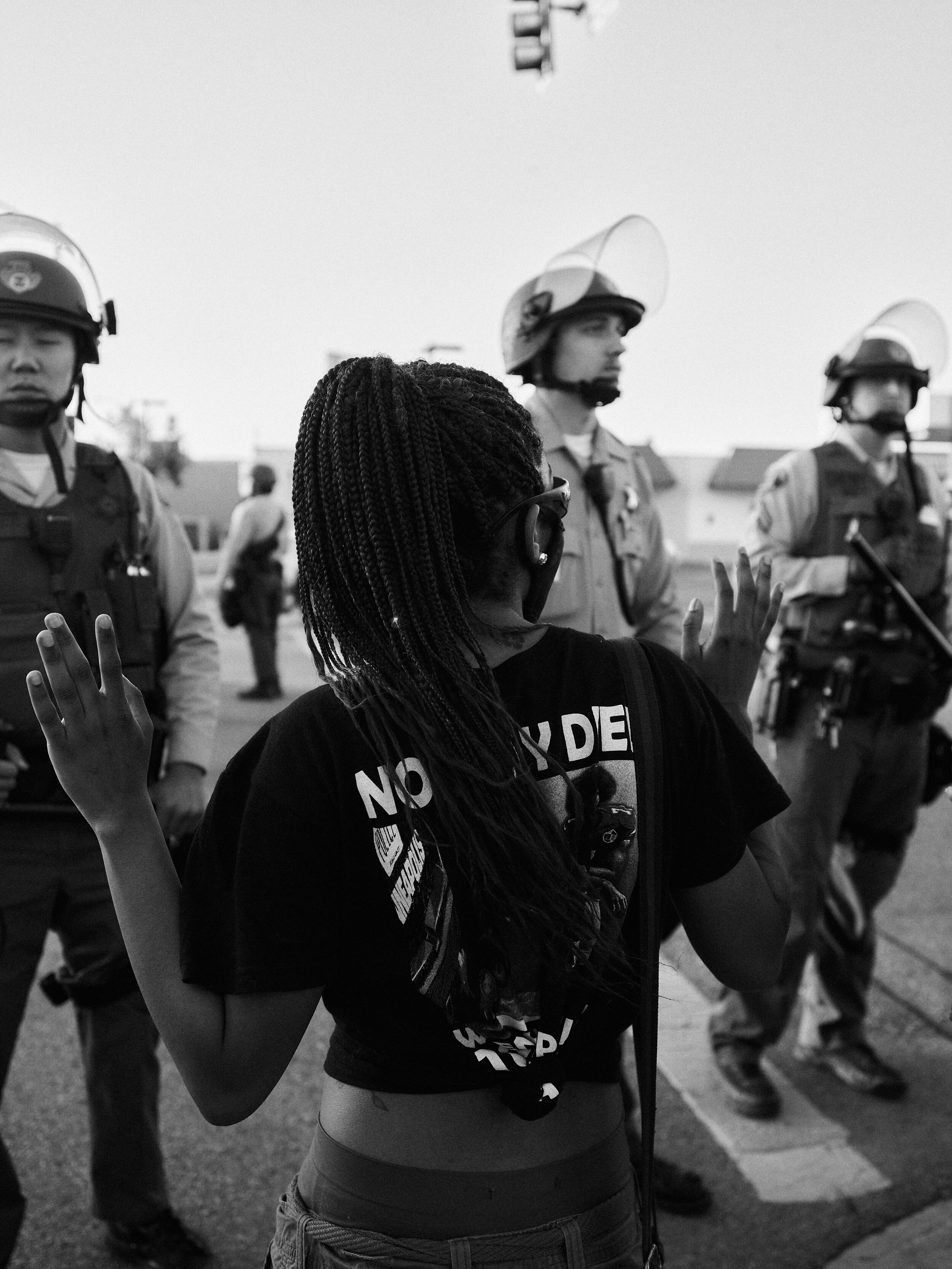 A young black woman puts her hands up to police in Palmdale