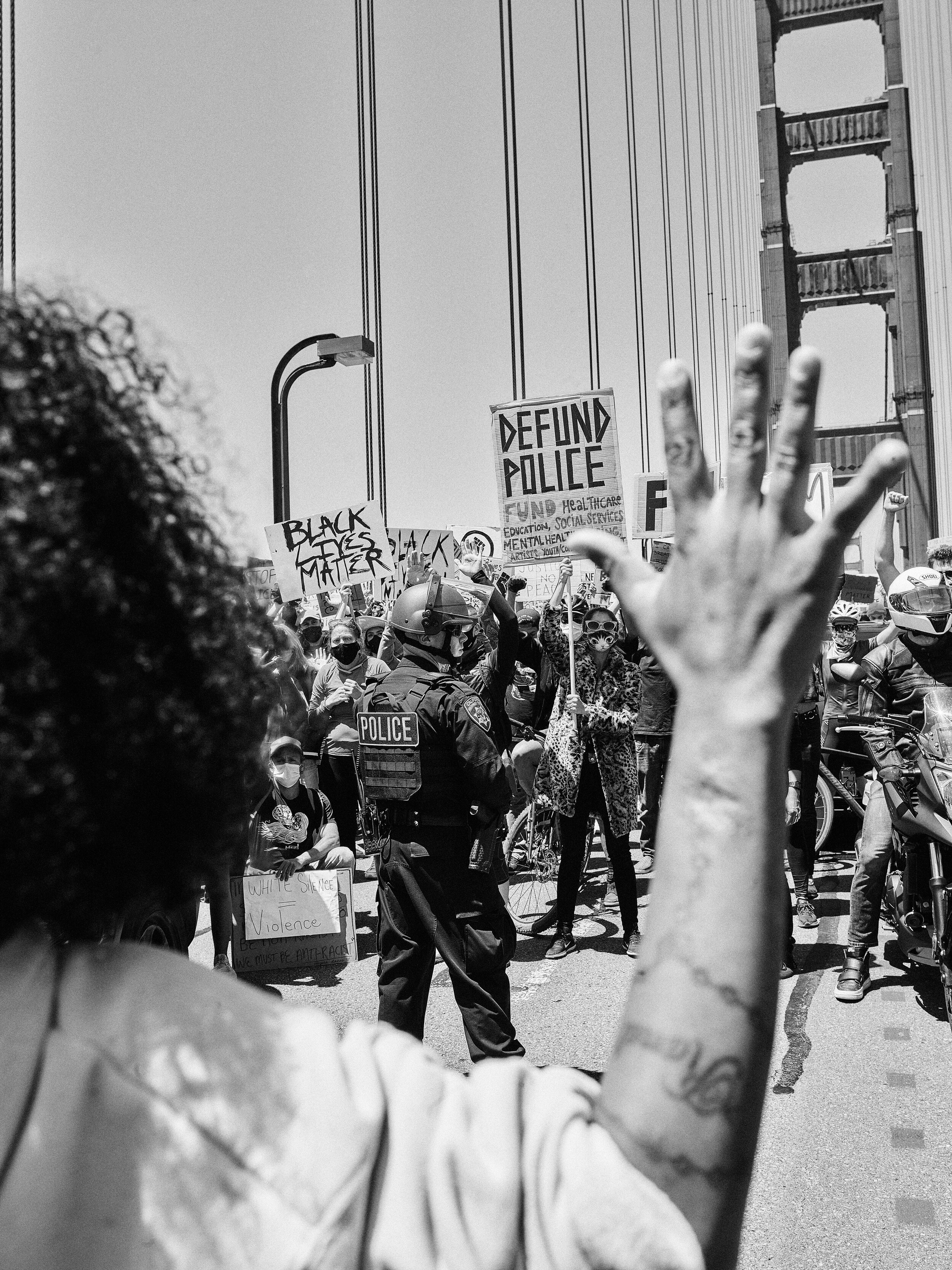Protestors surround police officers on the Golden Gate Bridge