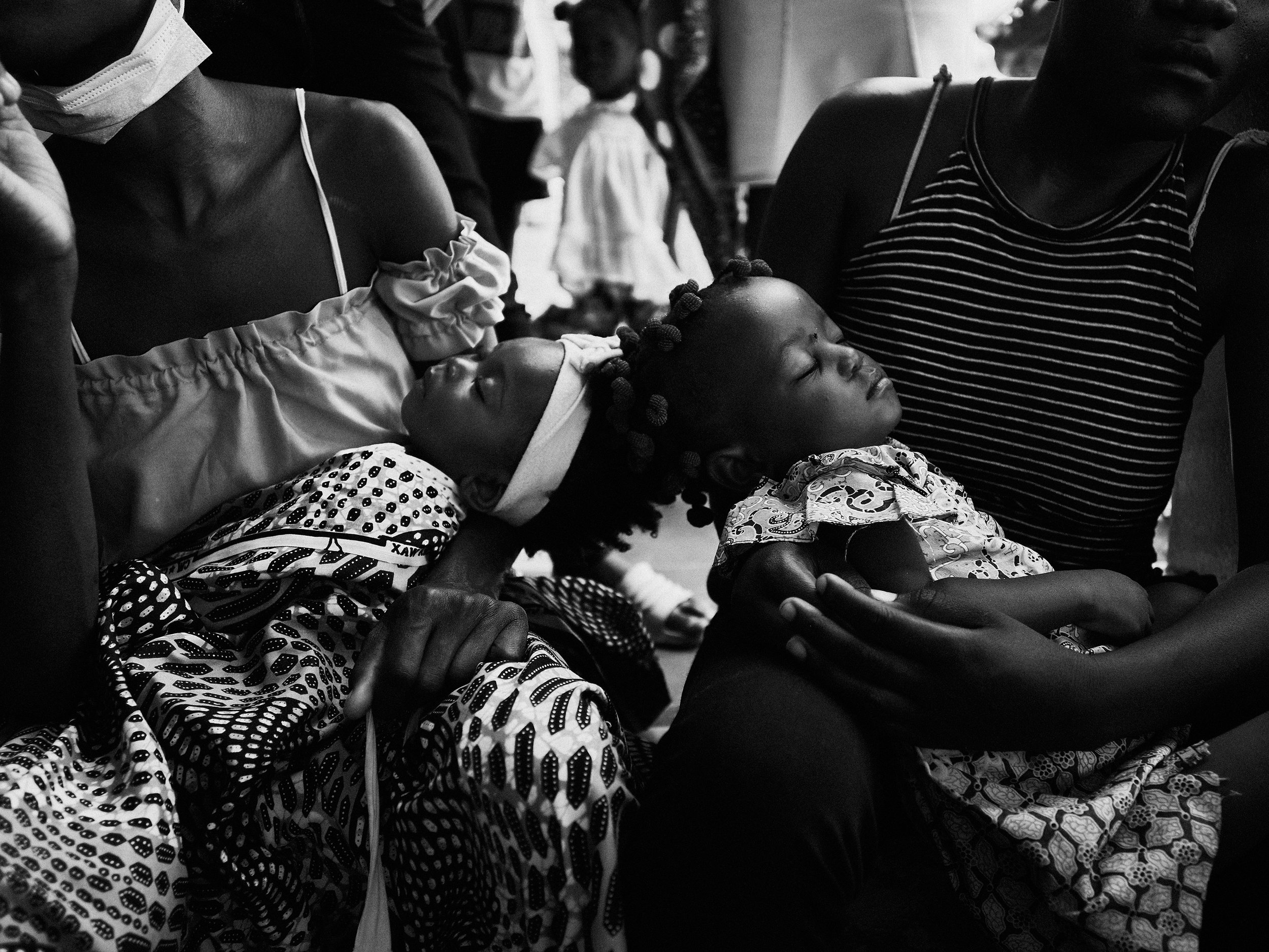 Twin daughters waiting for malnutrition screening at a WFP clinic in Angola